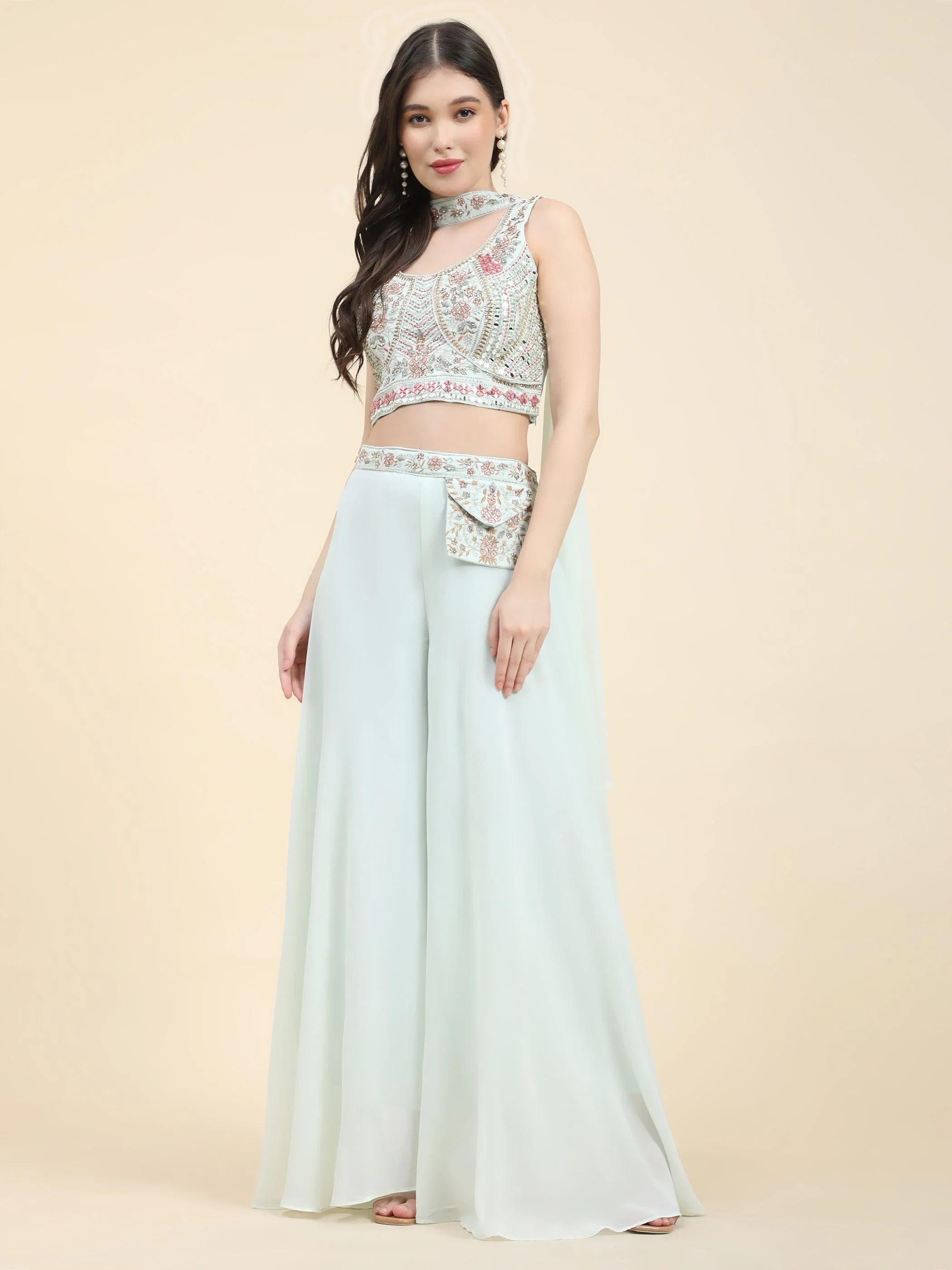 Woman in pastel green embroidered crop top with flared palazzo pants, Indian ethnic wear
