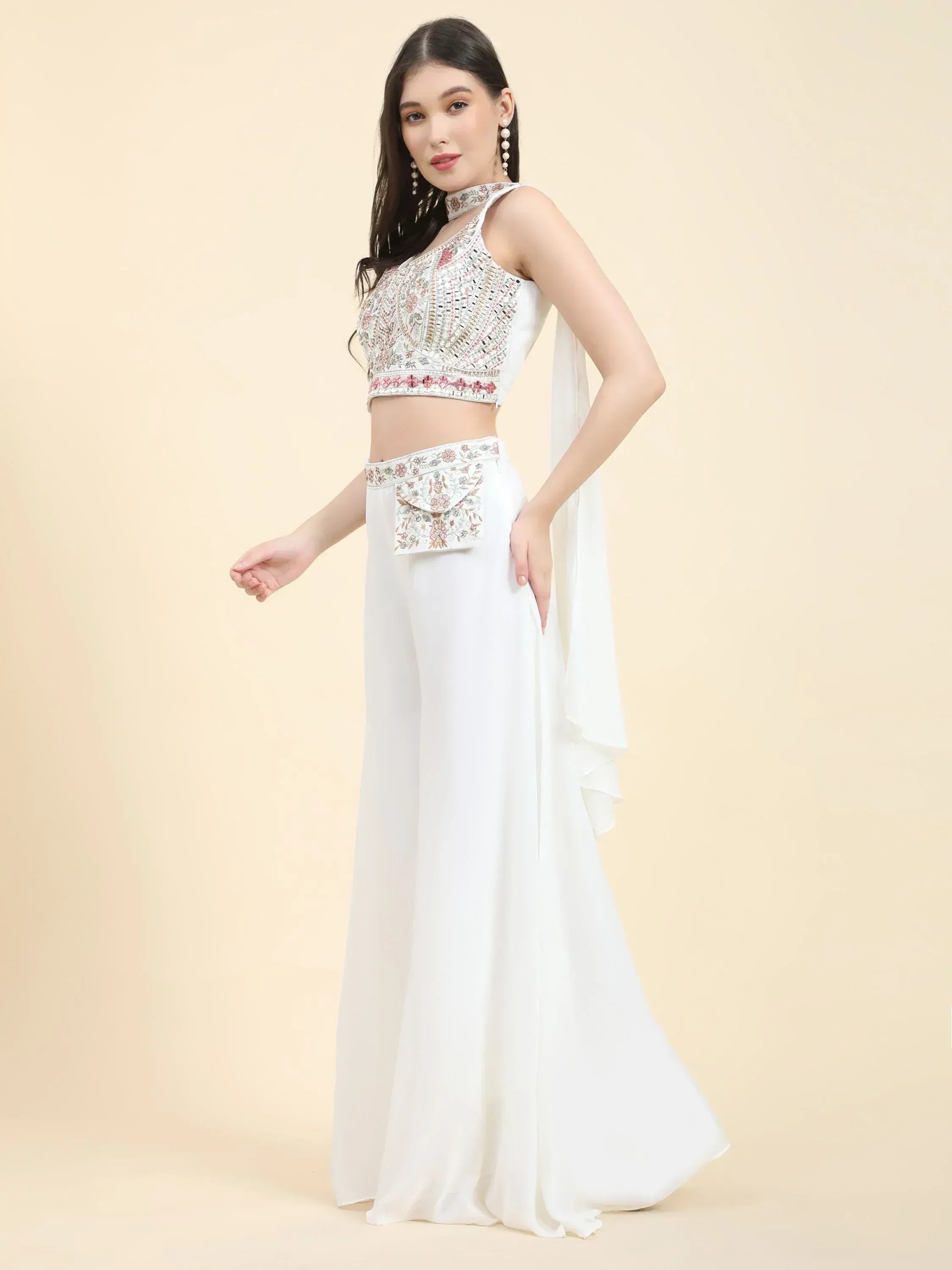 Woman wearing white embroidered Indian palazzo set with crop top and dupatta