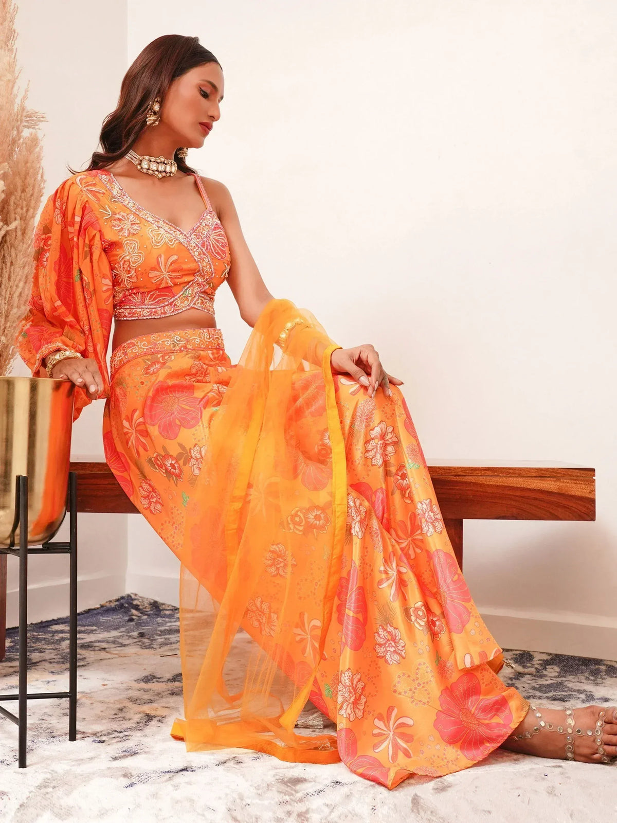 Orange floral lehenga choli with intricate embroidery and sheer dupatta for ethnic wear
