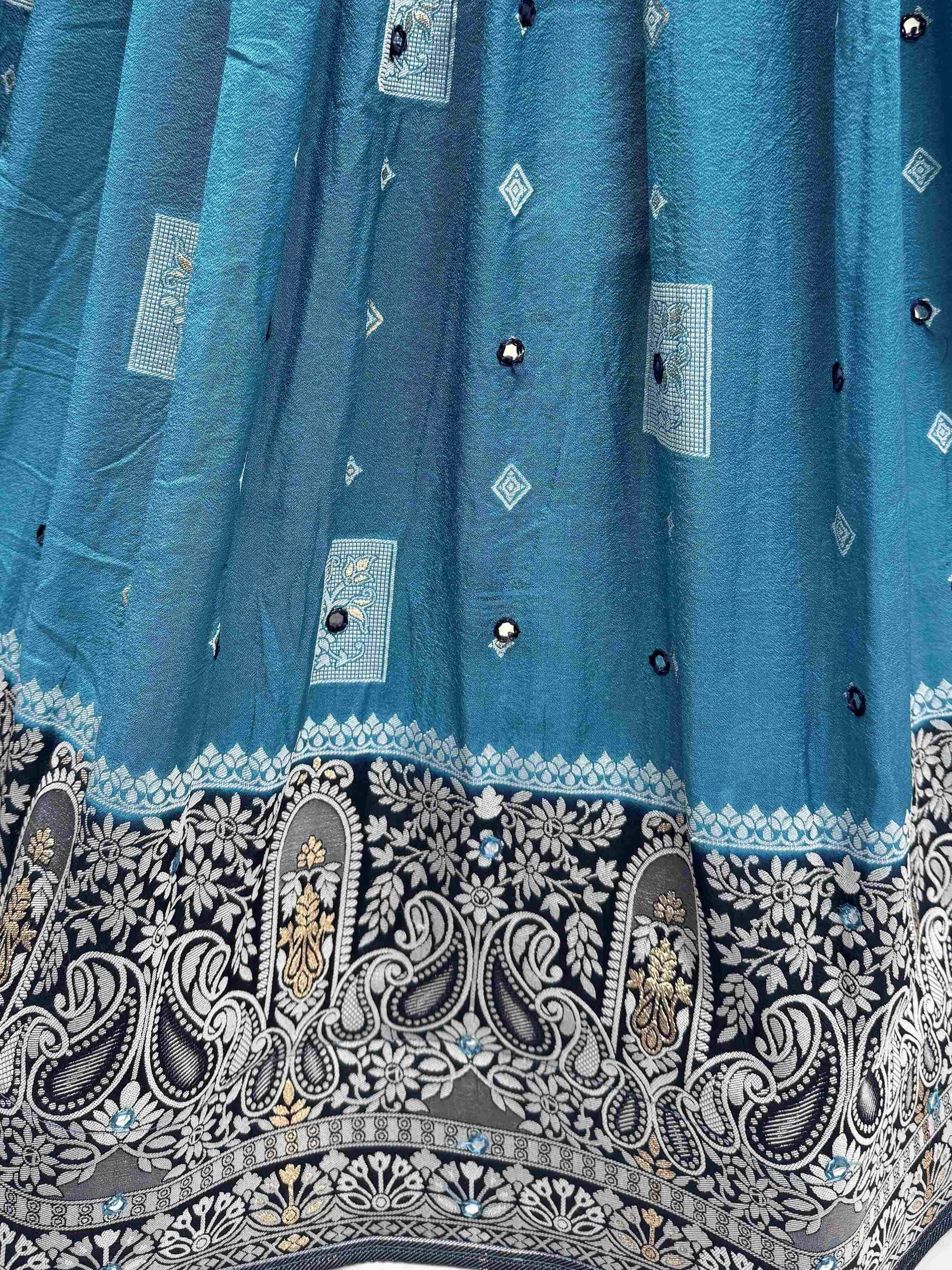 Teal ethnic skirt with intricate silver-gold embroidery and mirror work, perfect for Indian festive wear.
