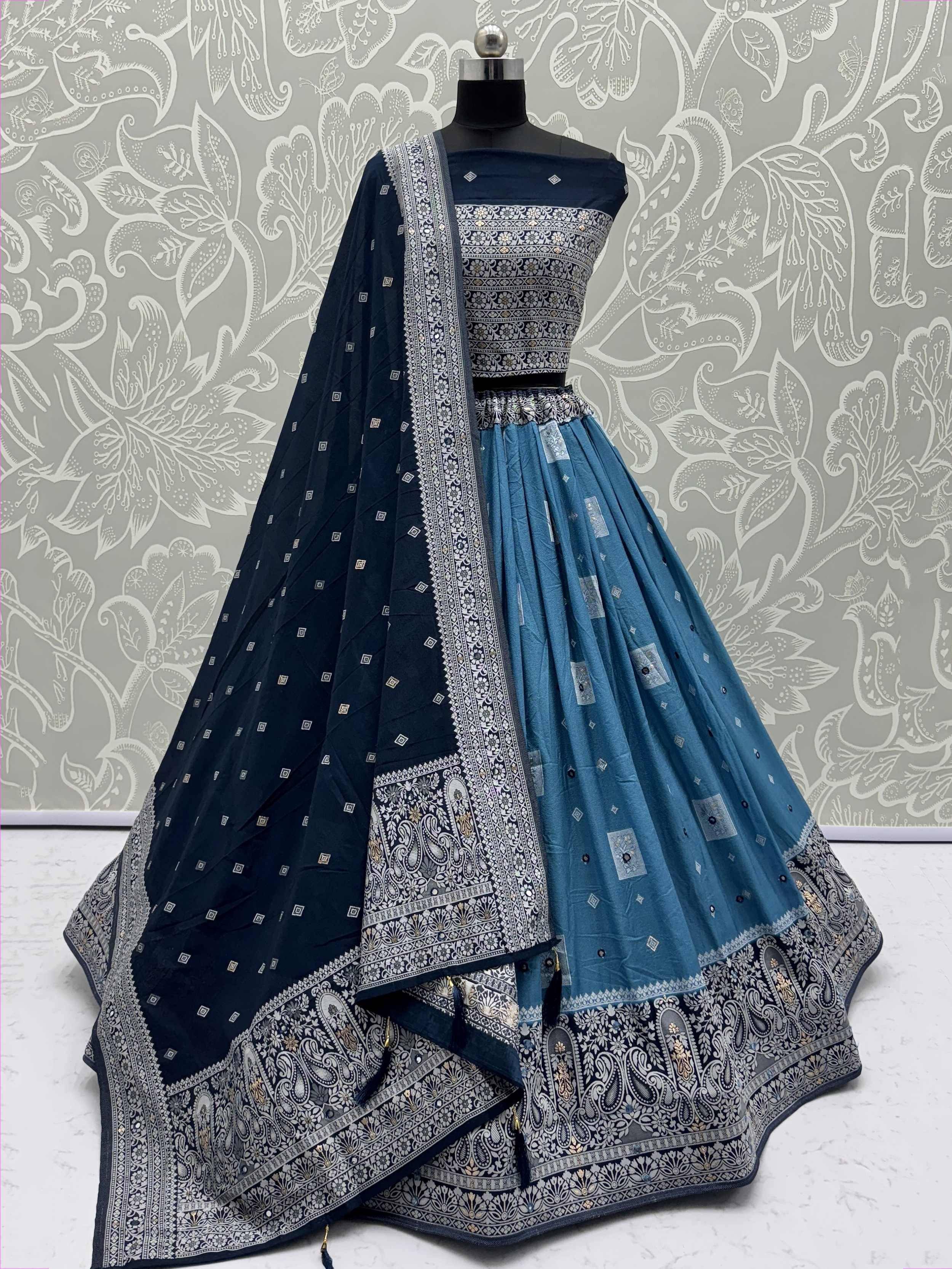 Navy blue and teal lehenga choli with intricate silver paisley print and matching dupatta, perfect for ethnic occasions.