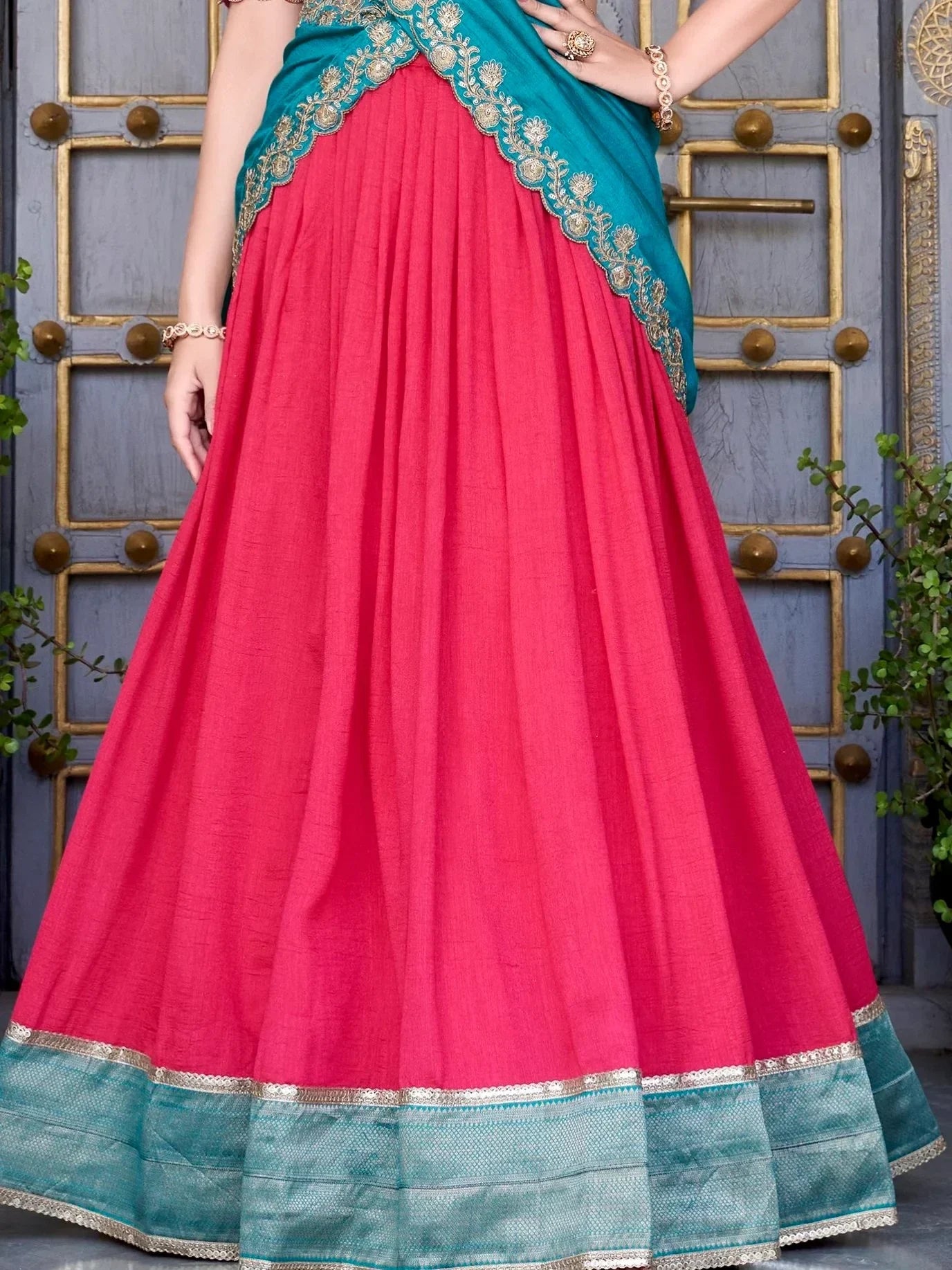 Pink lehenga with teal dupatta and gold embroidery, ethnic Indian wear for festive occasions