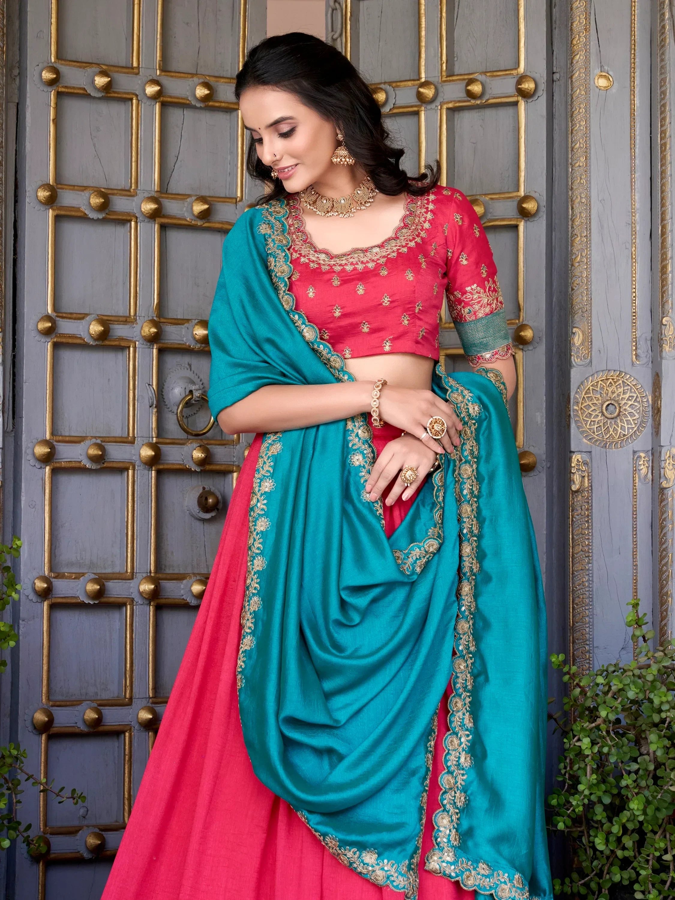 Pink and teal designer lehenga choli with gold embroidery, perfect for Indian ethnic wear occasions