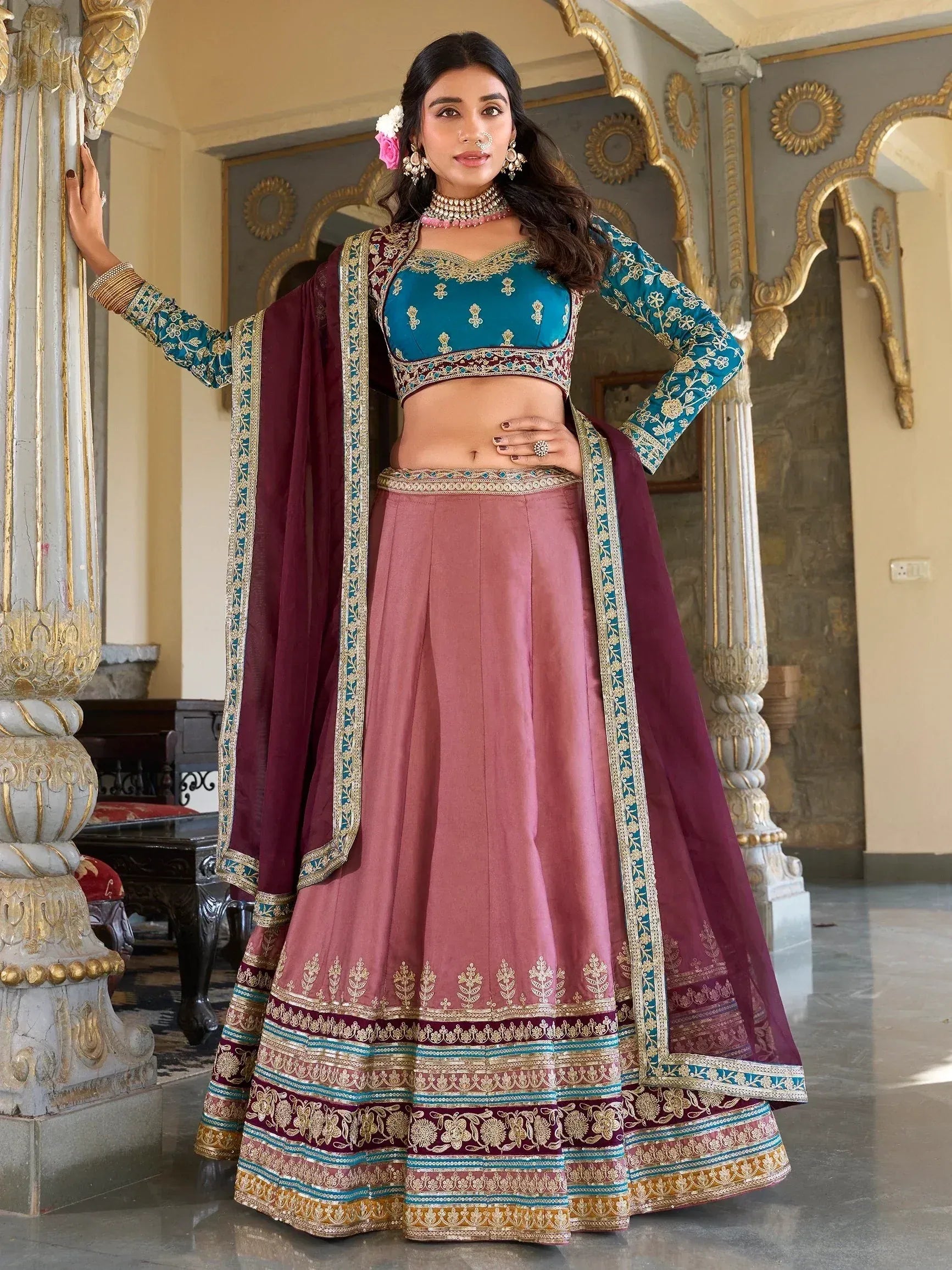 Teal and maroon designer lehenga choli with gold embroidery, perfect for Indian weddings and festive occasions