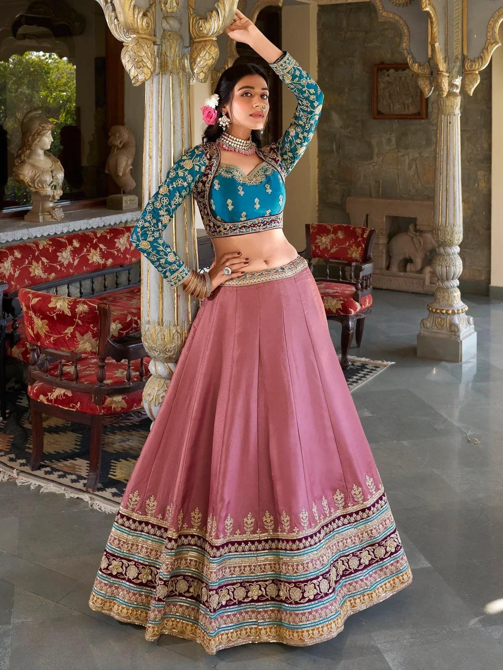 Teal and pink embroidered lehenga choli with gold detailing, perfect for Indian weddings and festive occasions