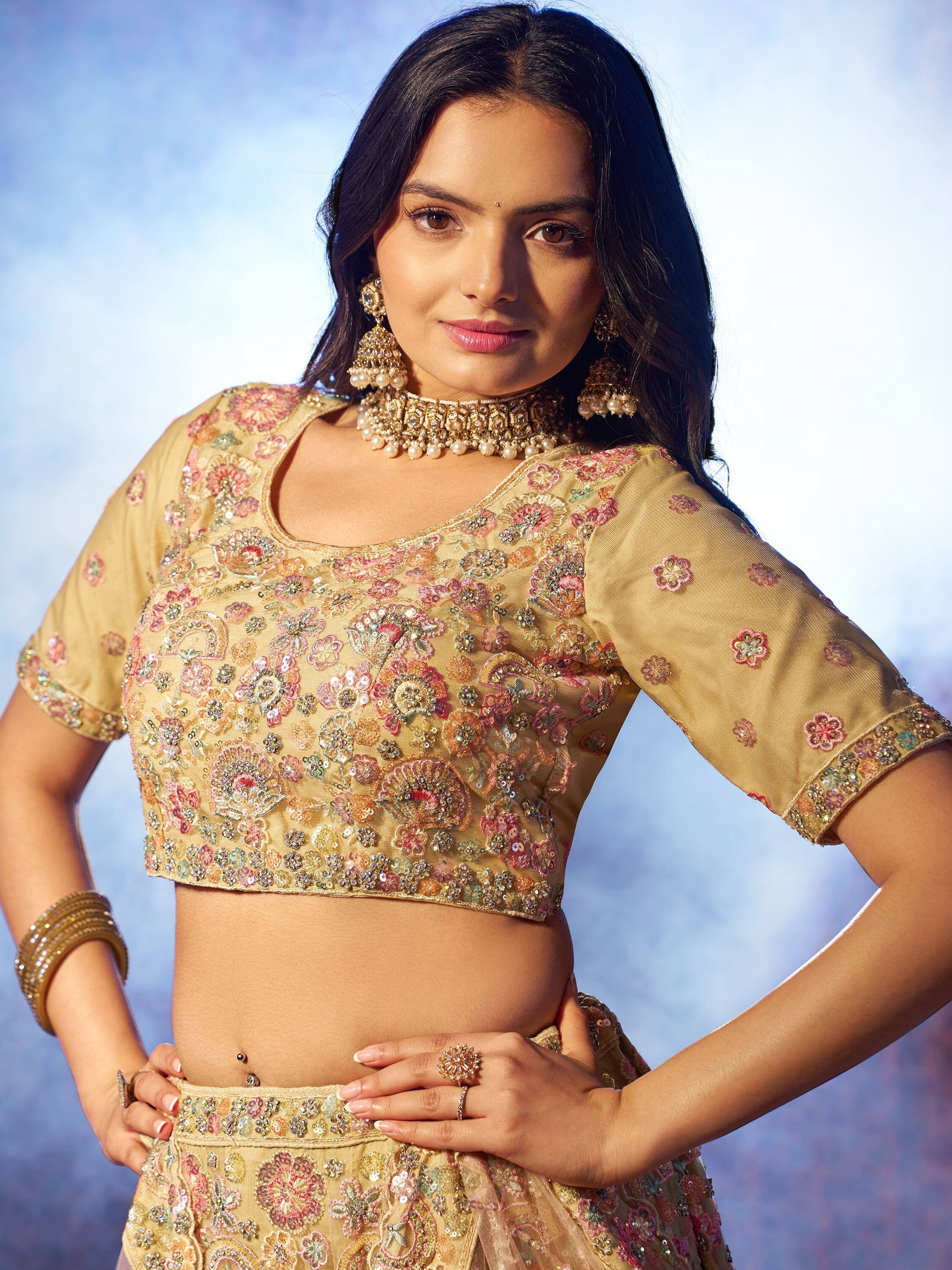 Gold floral embroidered lehenga choli with mirror work, perfect for Indian weddings and festive occasions.
