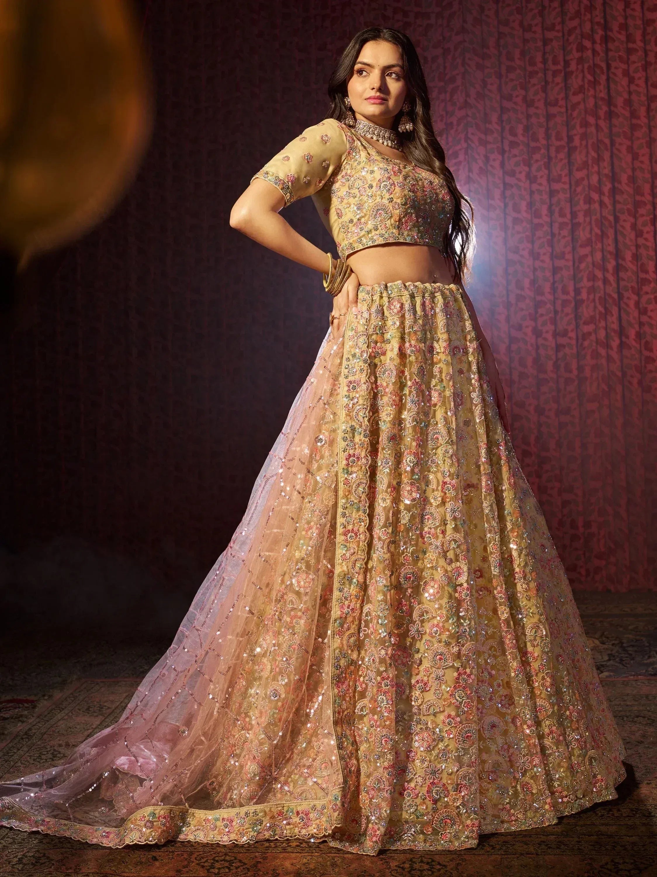 Elegant gold lehenga choli with floral embroidery and sequins, perfect for Indian weddings and festive occasions.