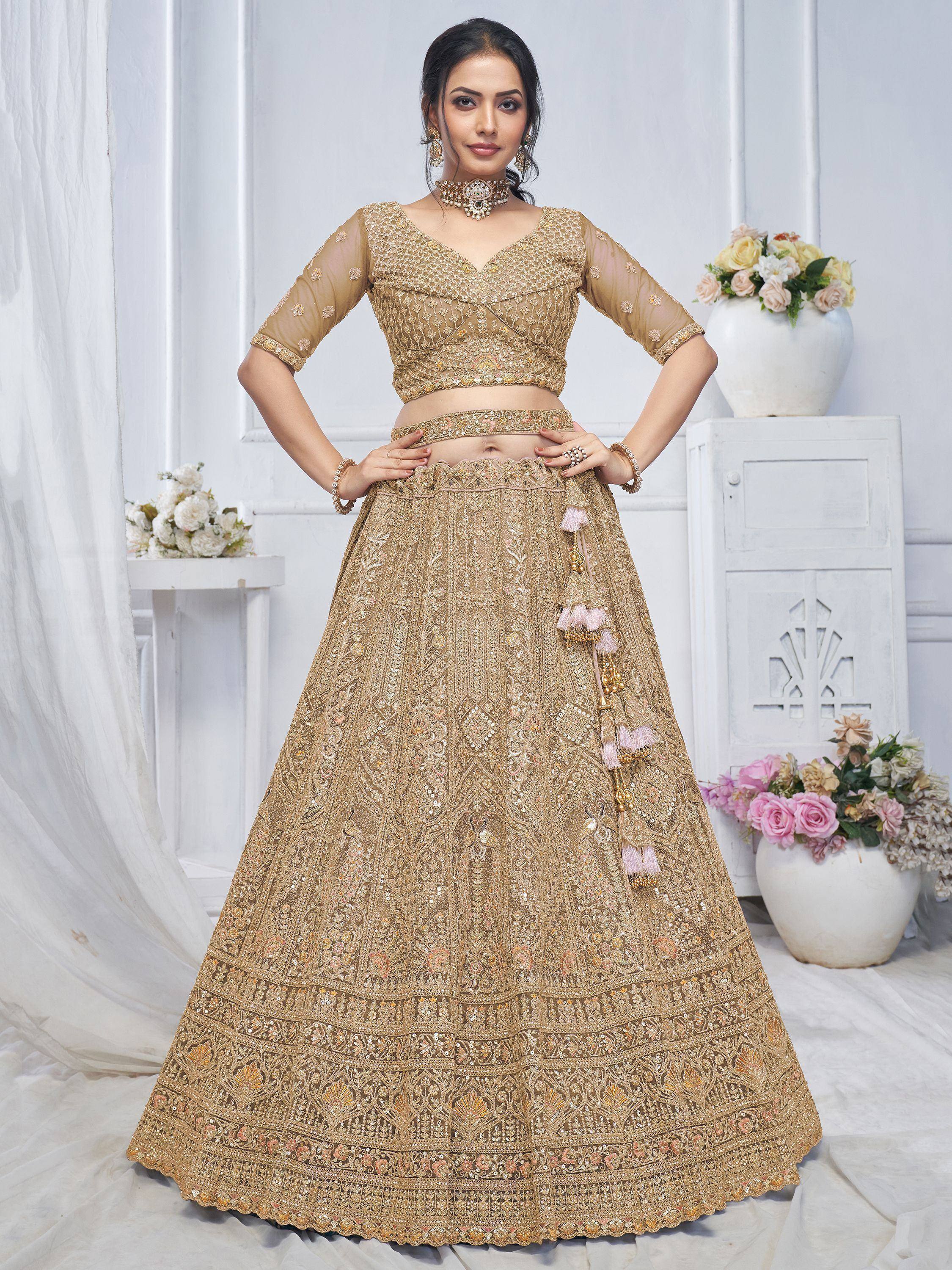 Golden embroidered lehenga choli with tassels, perfect for Indian weddings and festive occasions
