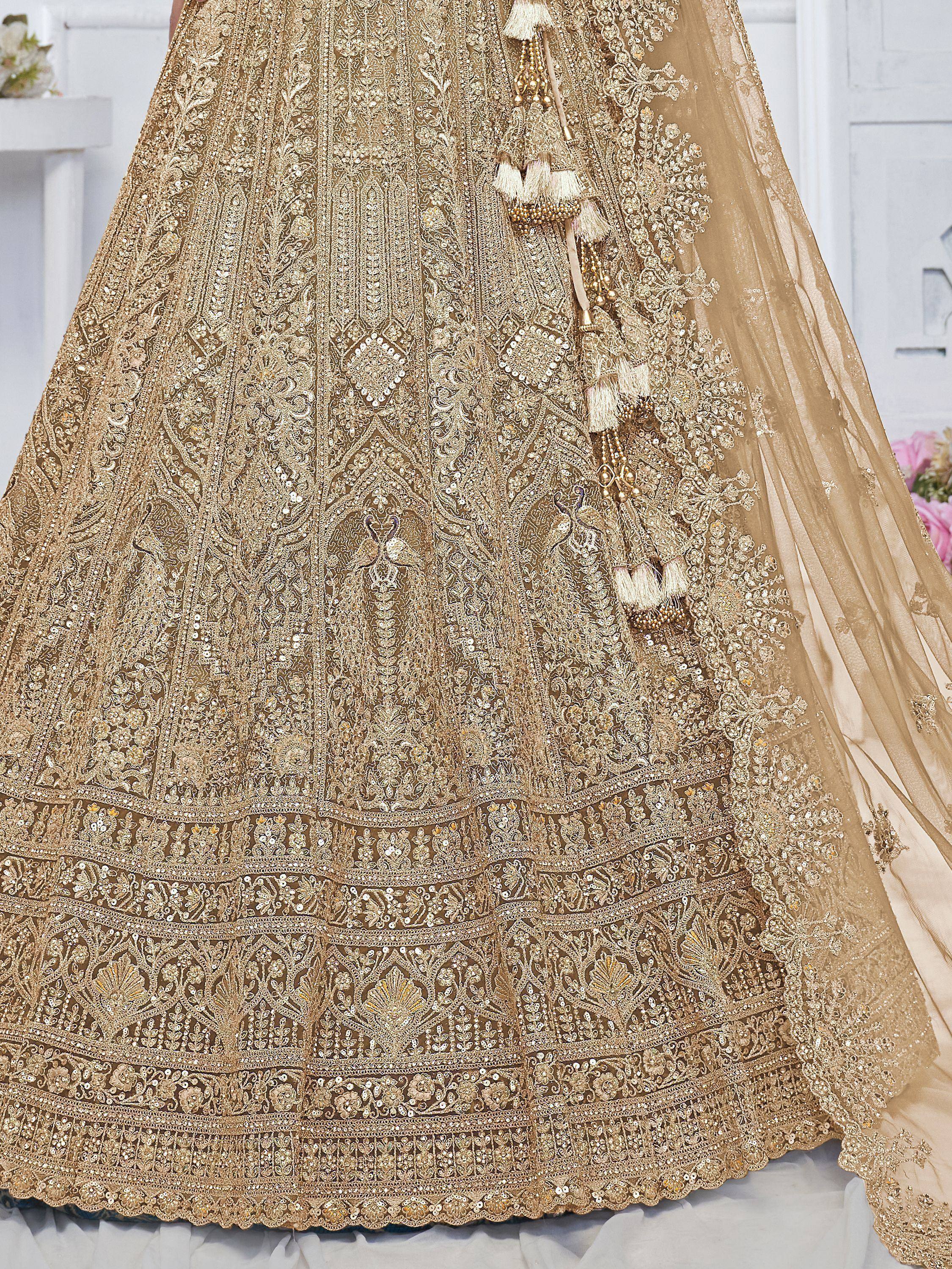 Golden designer lehenga choli with intricate embroidery and tassels, perfect for Indian ethnic wear