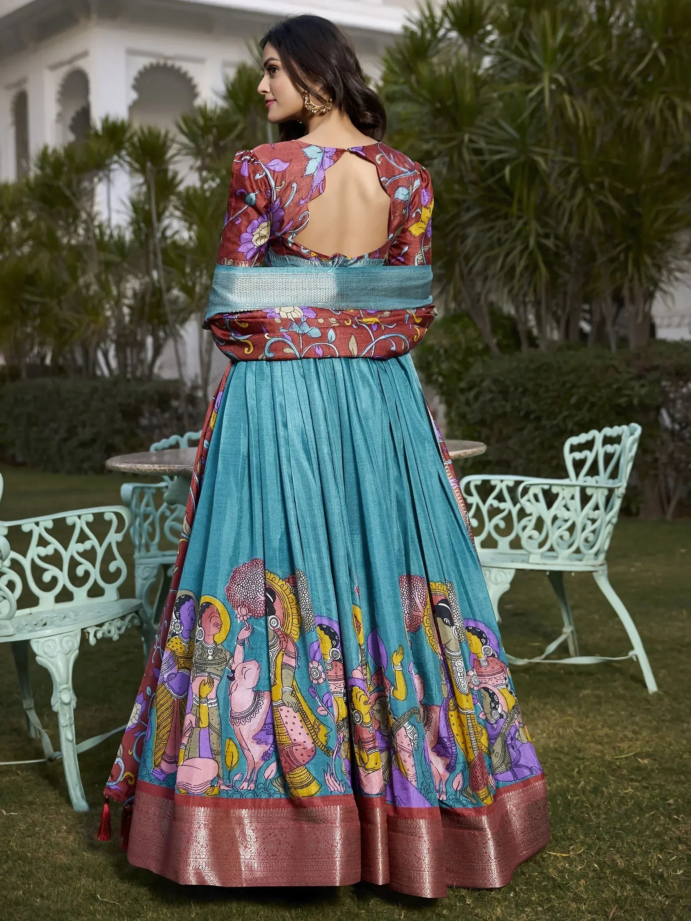 Woman in colorful printed ethnic gown with back cutout, perfect for Indian occasions and festive wear.