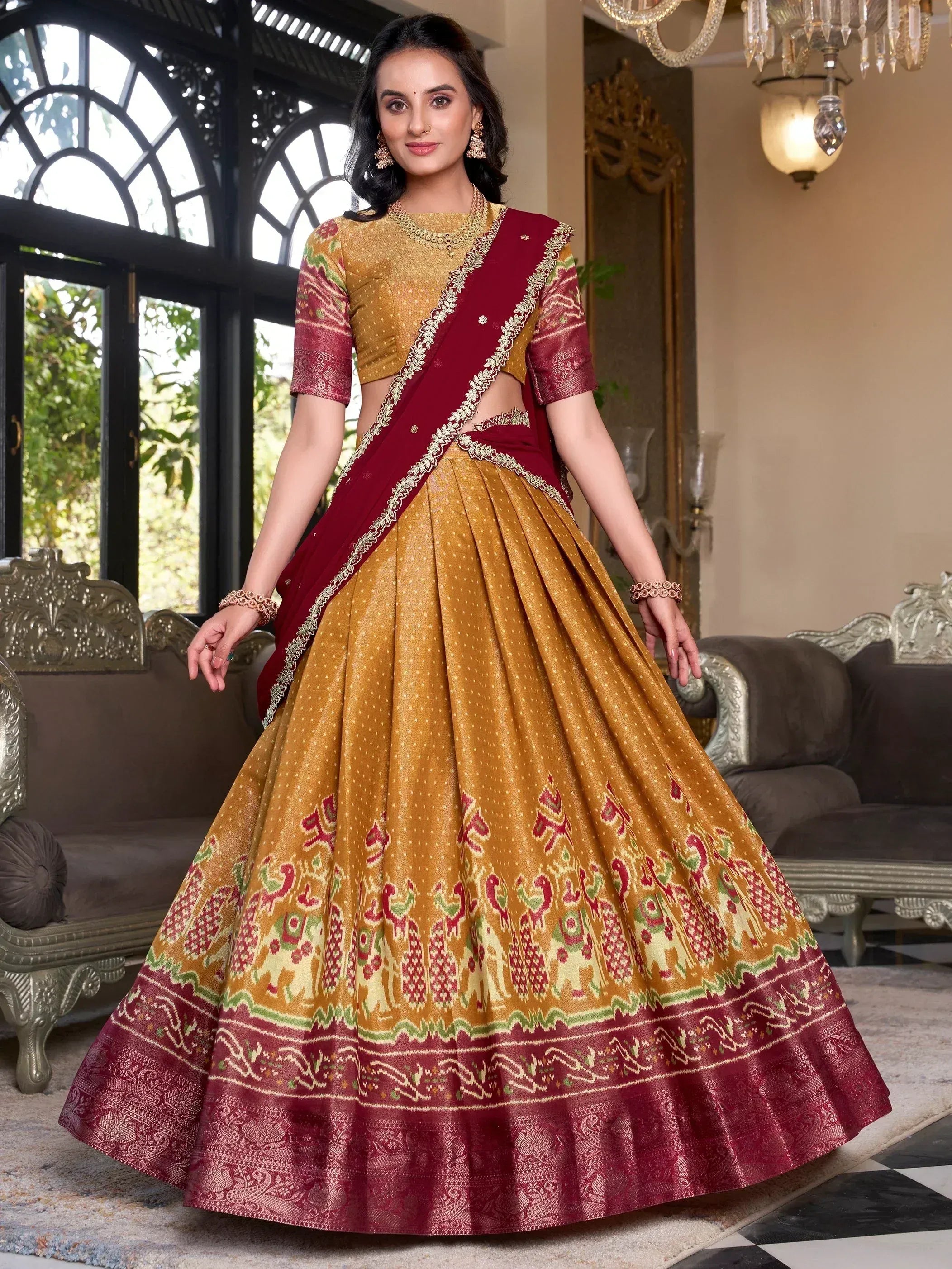 Elegant mustard and maroon lehenga choli with intricate ikat print and gold embroidery, perfect for Indian ethnic occasions.
