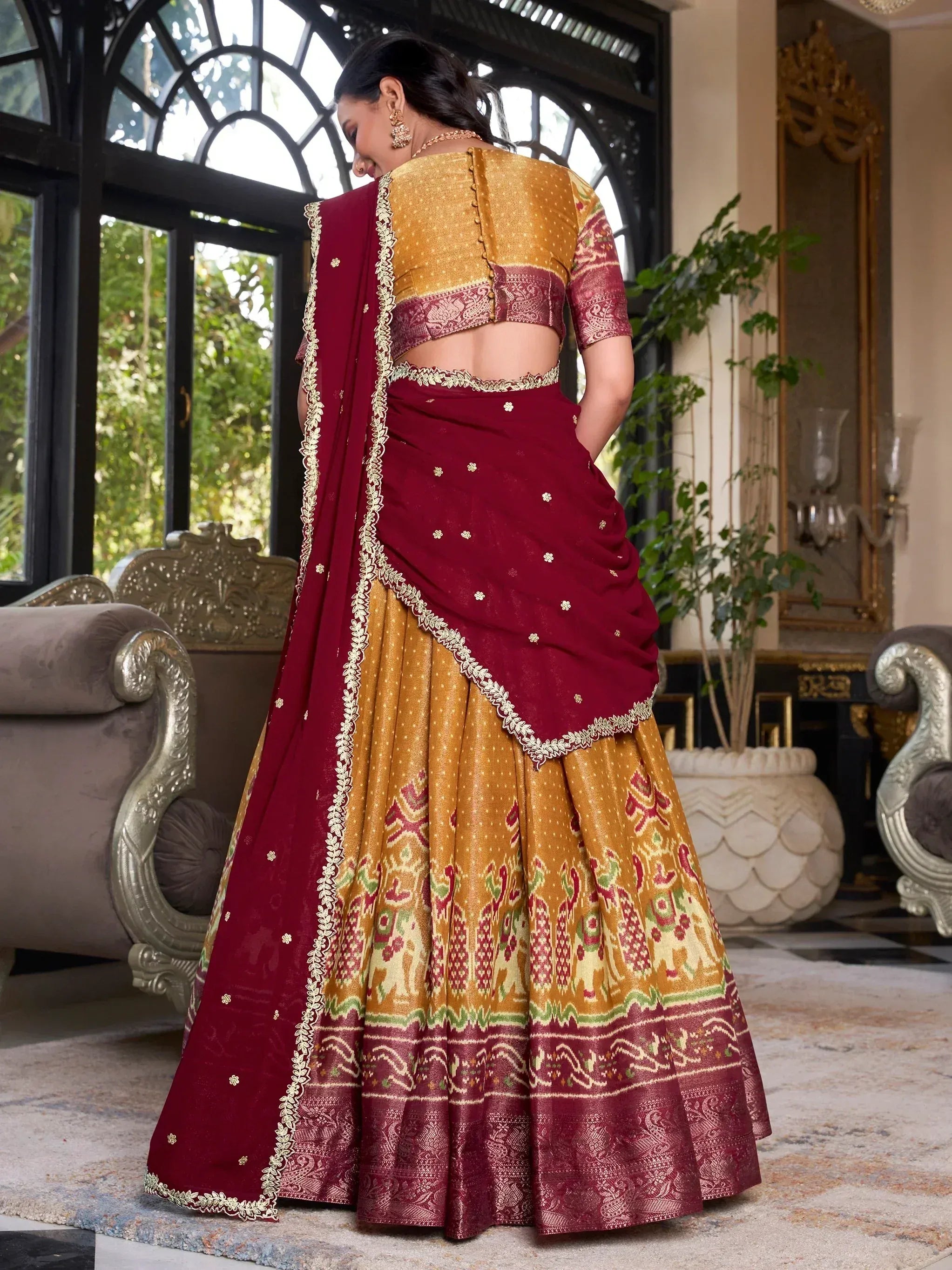 Maroon and gold designer lehenga choli with intricate embroidery, perfect for Indian ethnic wear occasions.