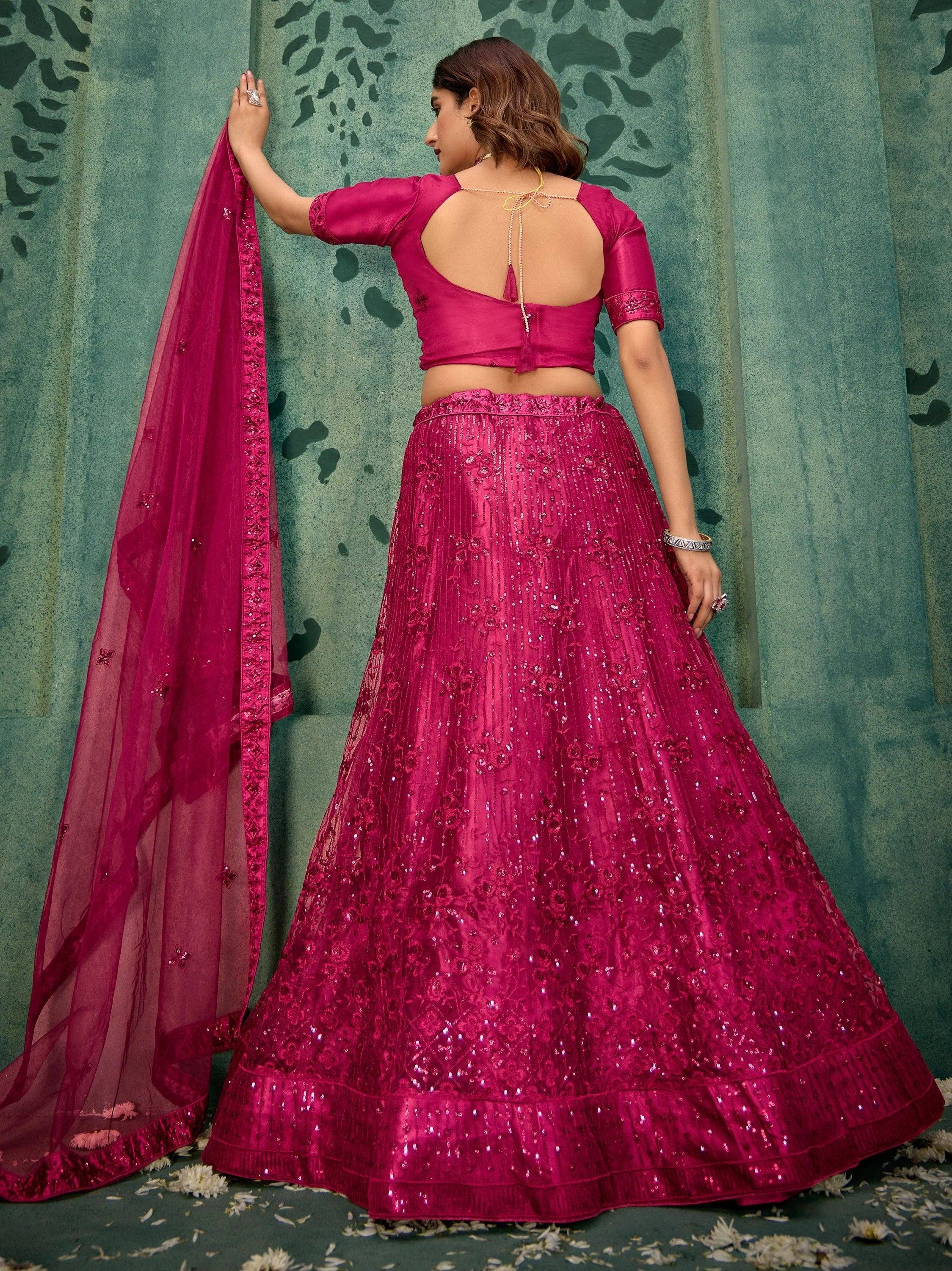 Fuchsia lehenga choli with sequin embroidery, backless blouse, and matching dupatta for Indian ethnic wear