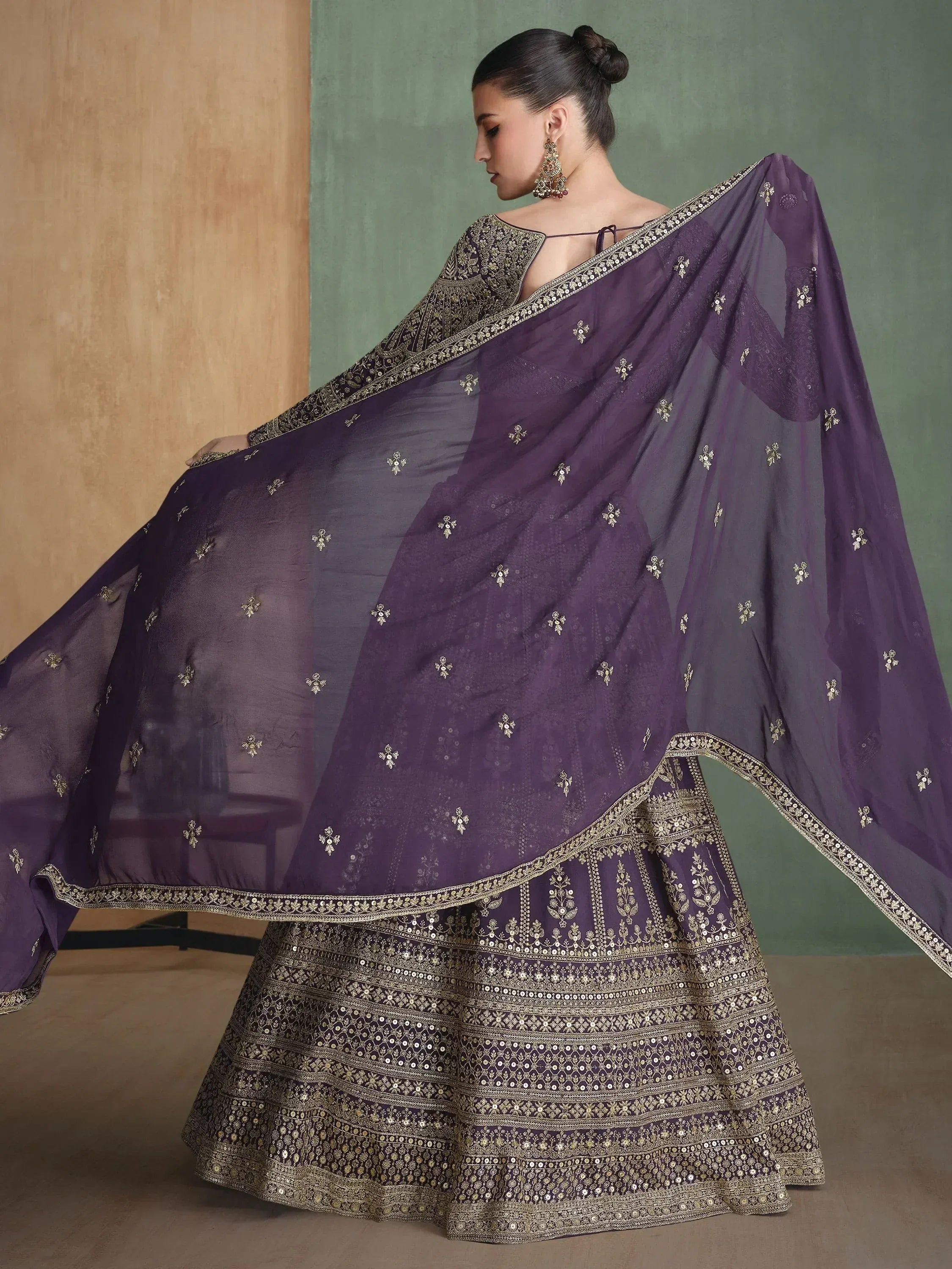 Purple designer lehenga choli with gold embroidery and sheer dupatta, ethnic Indian wear
