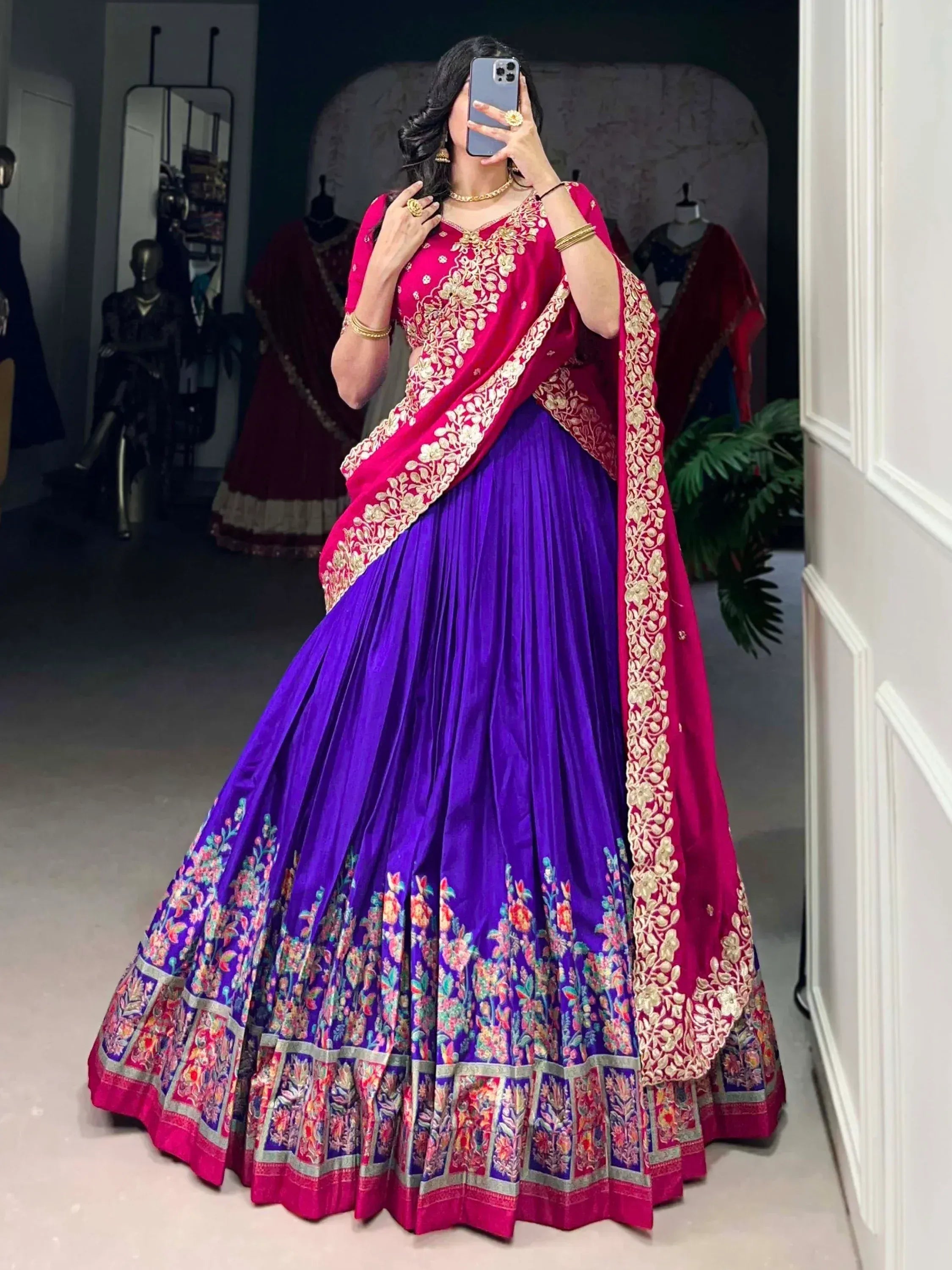 Purple and pink embroidered lehenga choli with floral border, perfect for Indian weddings and festive occasions.