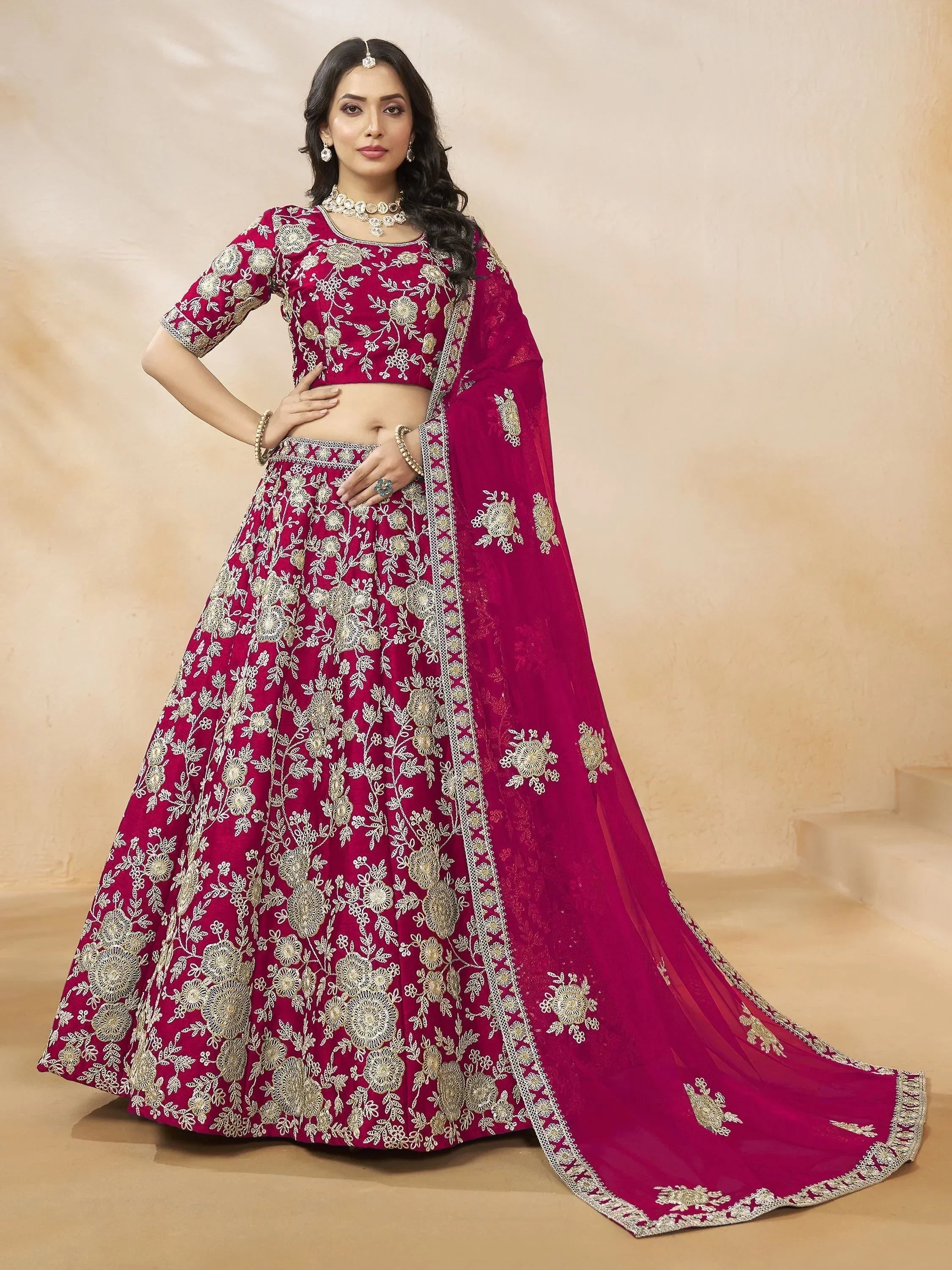Elegant maroon lehenga choli with gold floral embroidery, perfect for Indian weddings and festive occasions.