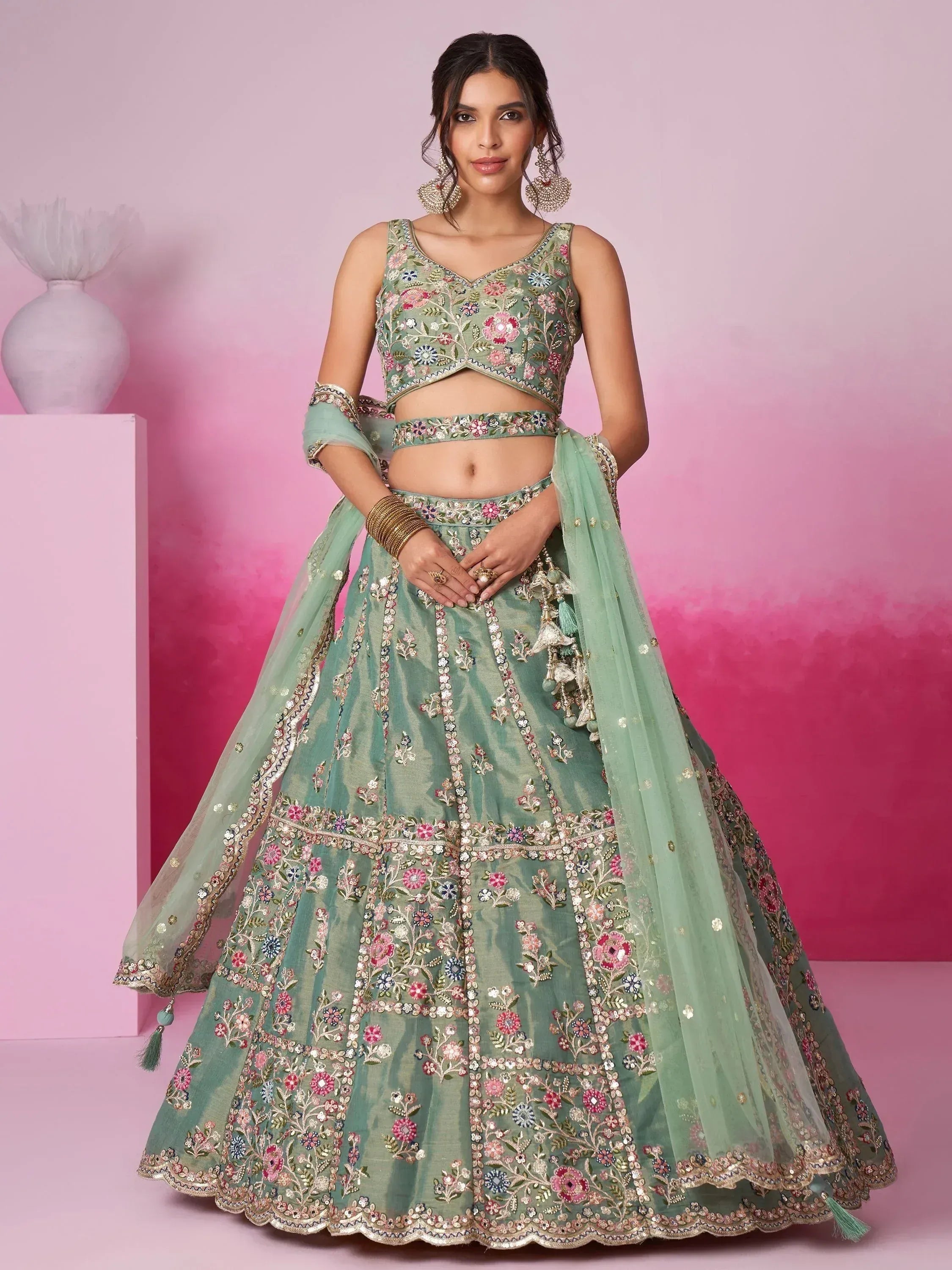 Mint green embroidered lehenga choli with floral motifs, perfect for Indian weddings and festive occasions.