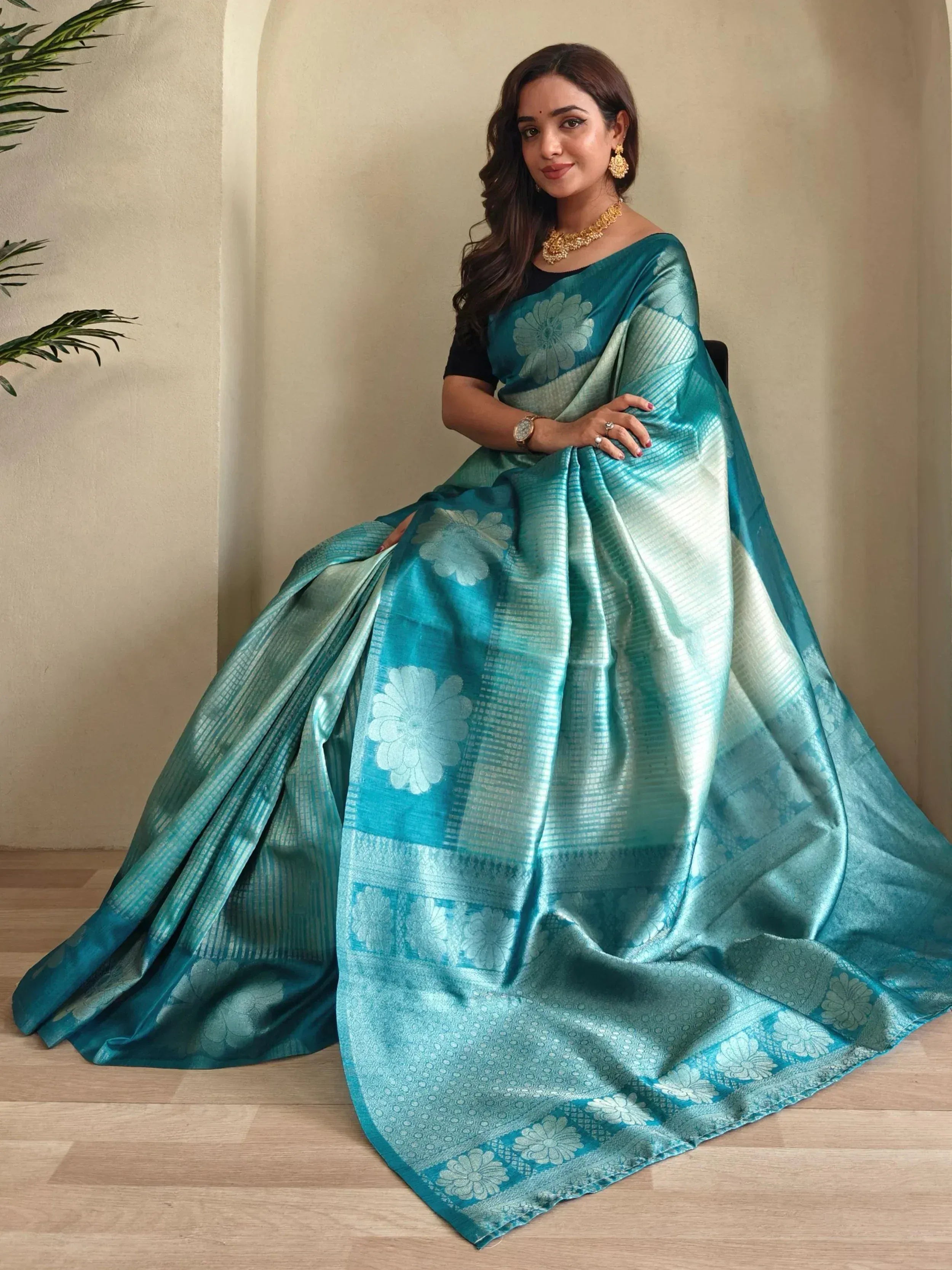 Teal floral saree with gold jewelry, elegant Indian ethnic wear for women