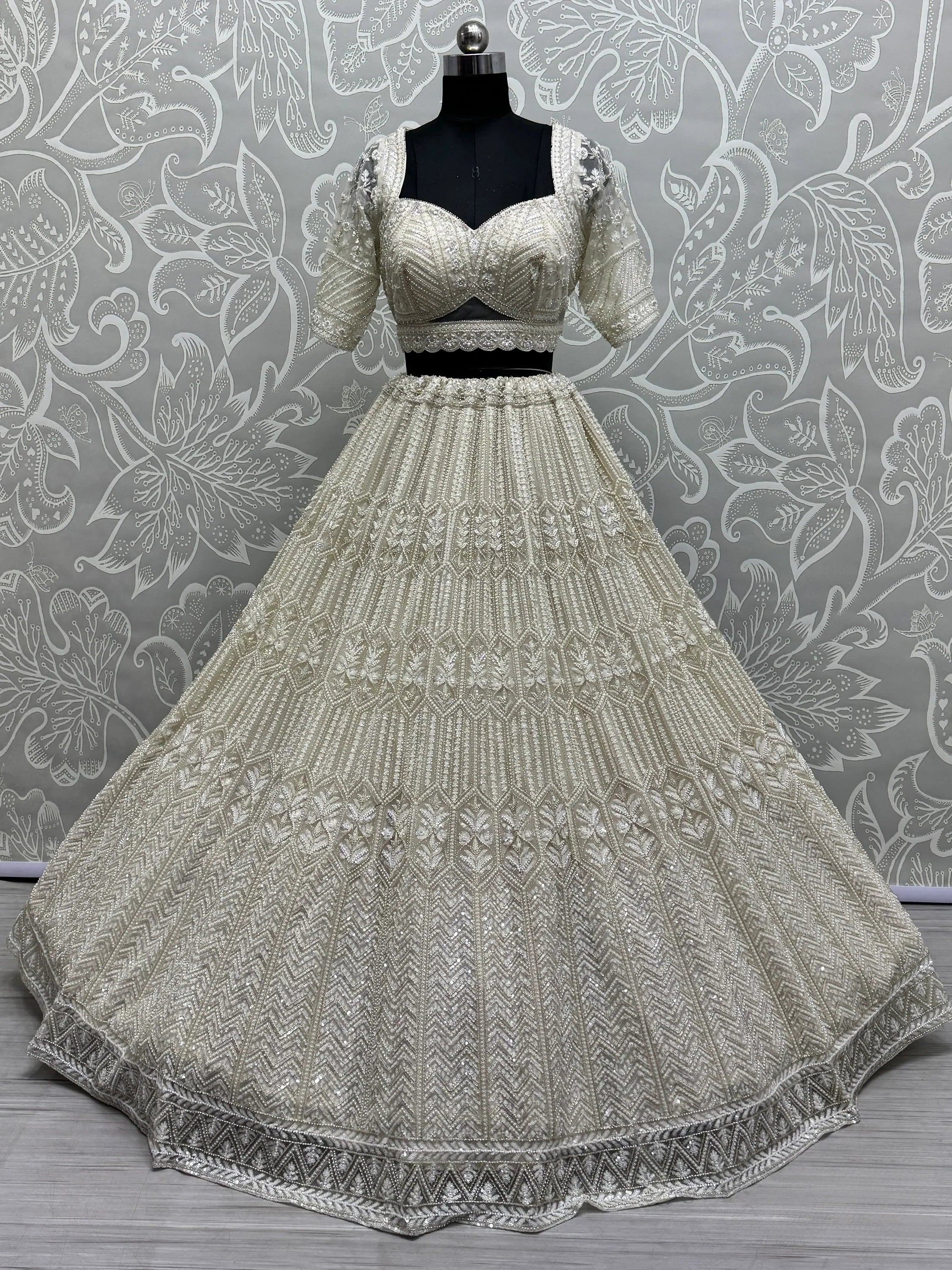 Elegant ivory lehenga choli with heavy embroidery, perfect for weddings and festive occasions.