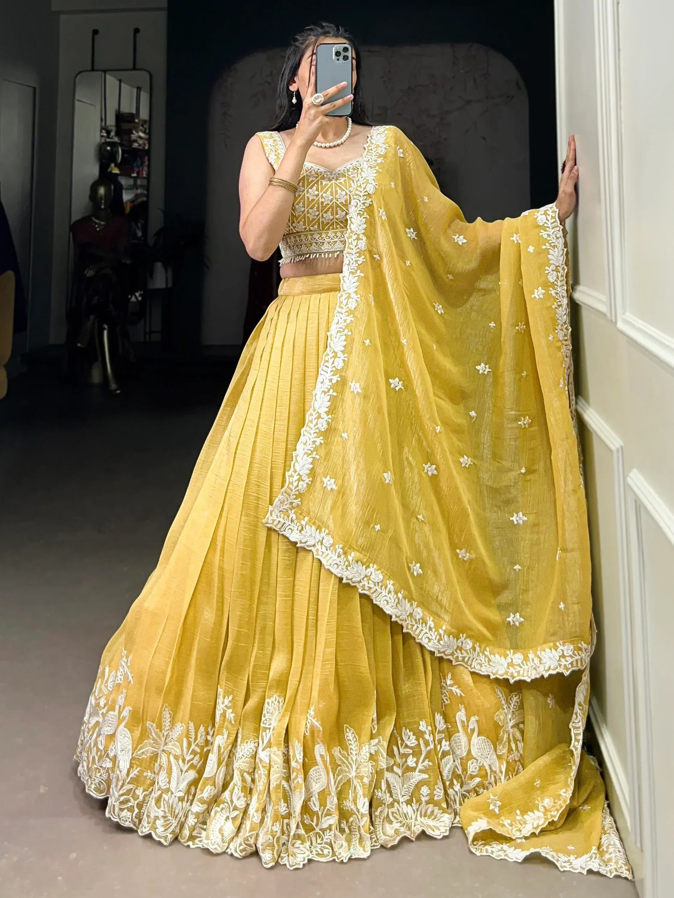 Yellow lehenga choli with white embroidery, floral and peacock motifs, ethnic wear for women