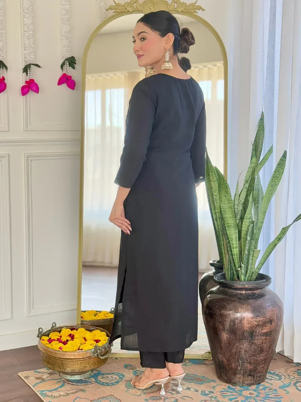 Elegant black ethnic kurti with side slit, paired with palazzo pants and statement earrings