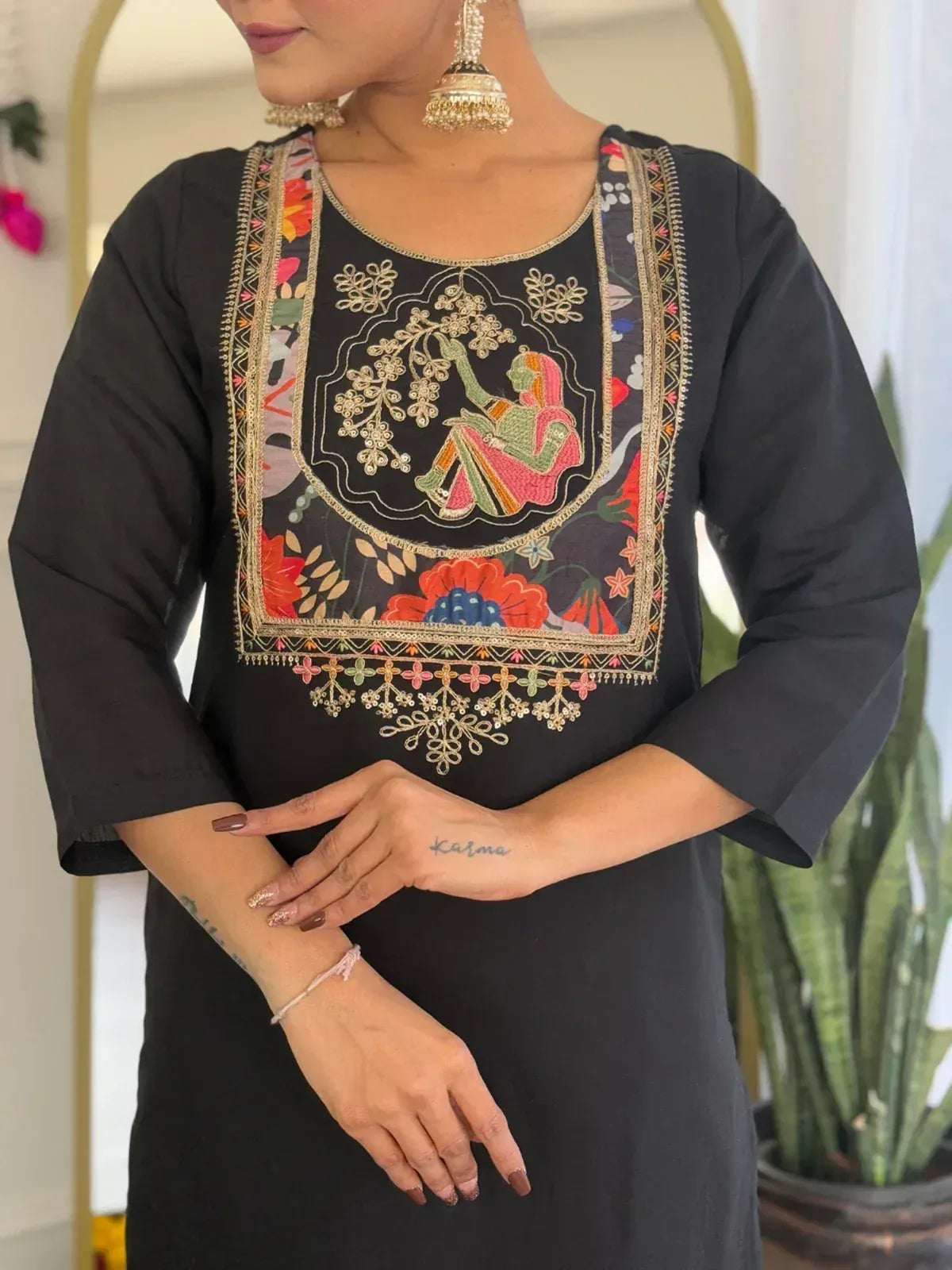 Black ethnic kurti with colorful floral and figurative embroidery, perfect for Indian wear