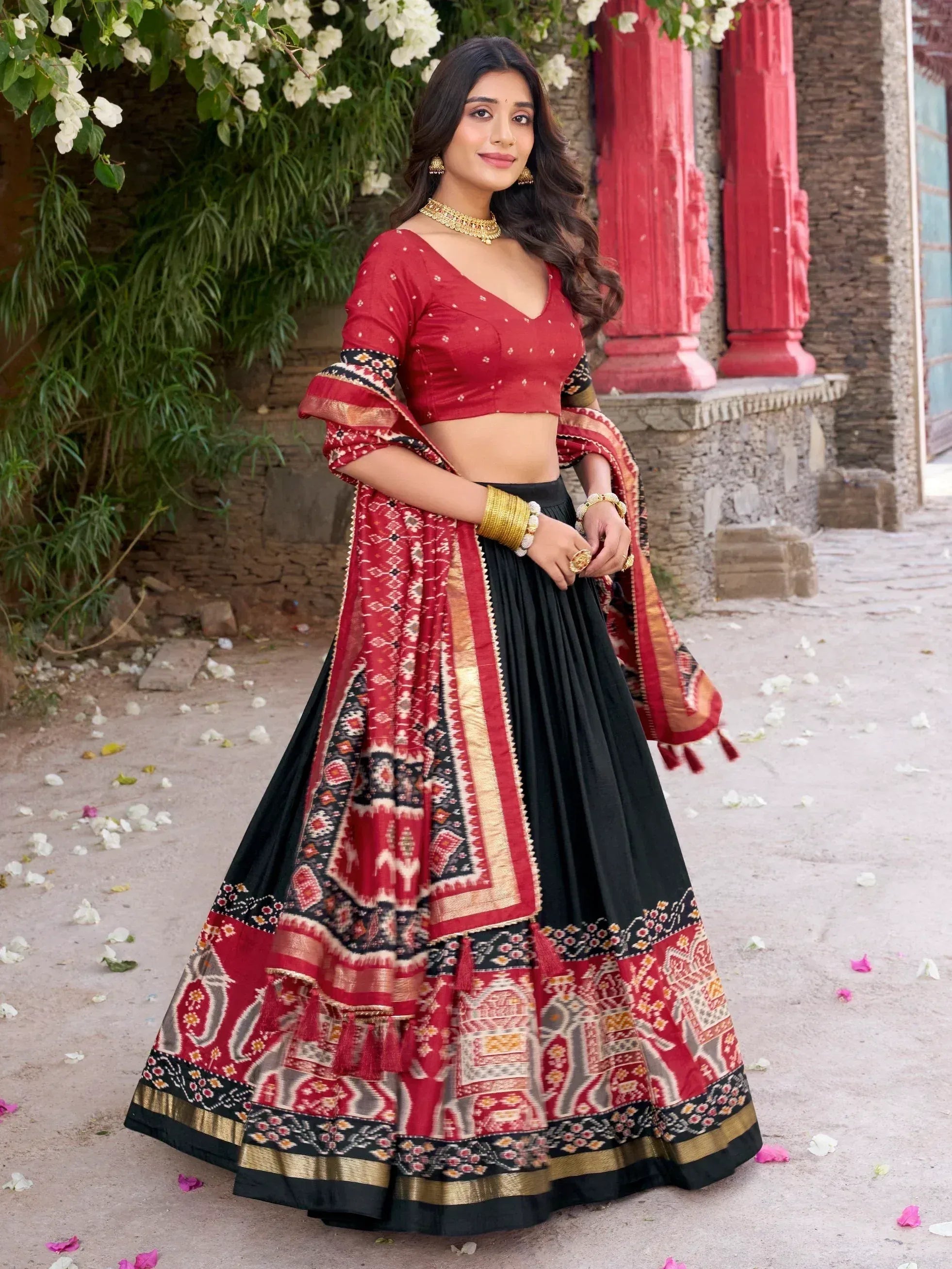 Red and black printed lehenga choli with gold embroidery, perfect for Indian ethnic wear occasions