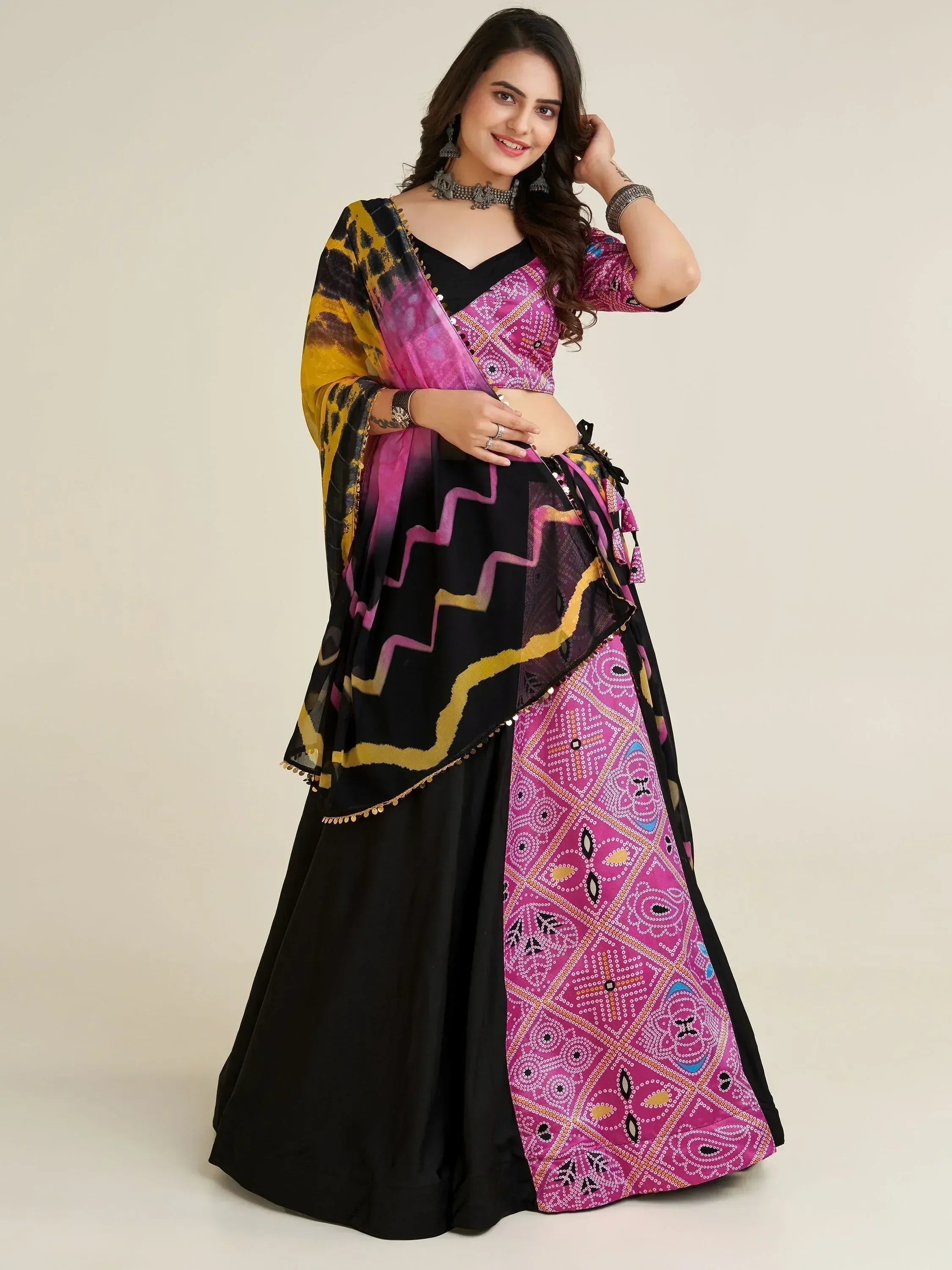 Woman in vibrant pink and black printed lehenga choli with matching dupatta, Indian ethnic wear