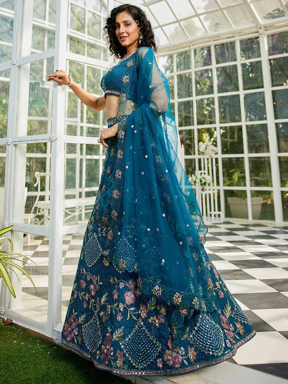 Teal blue embroidered lehenga choli with floral motifs and sheer dupatta, perfect for Indian ethnic occasions
