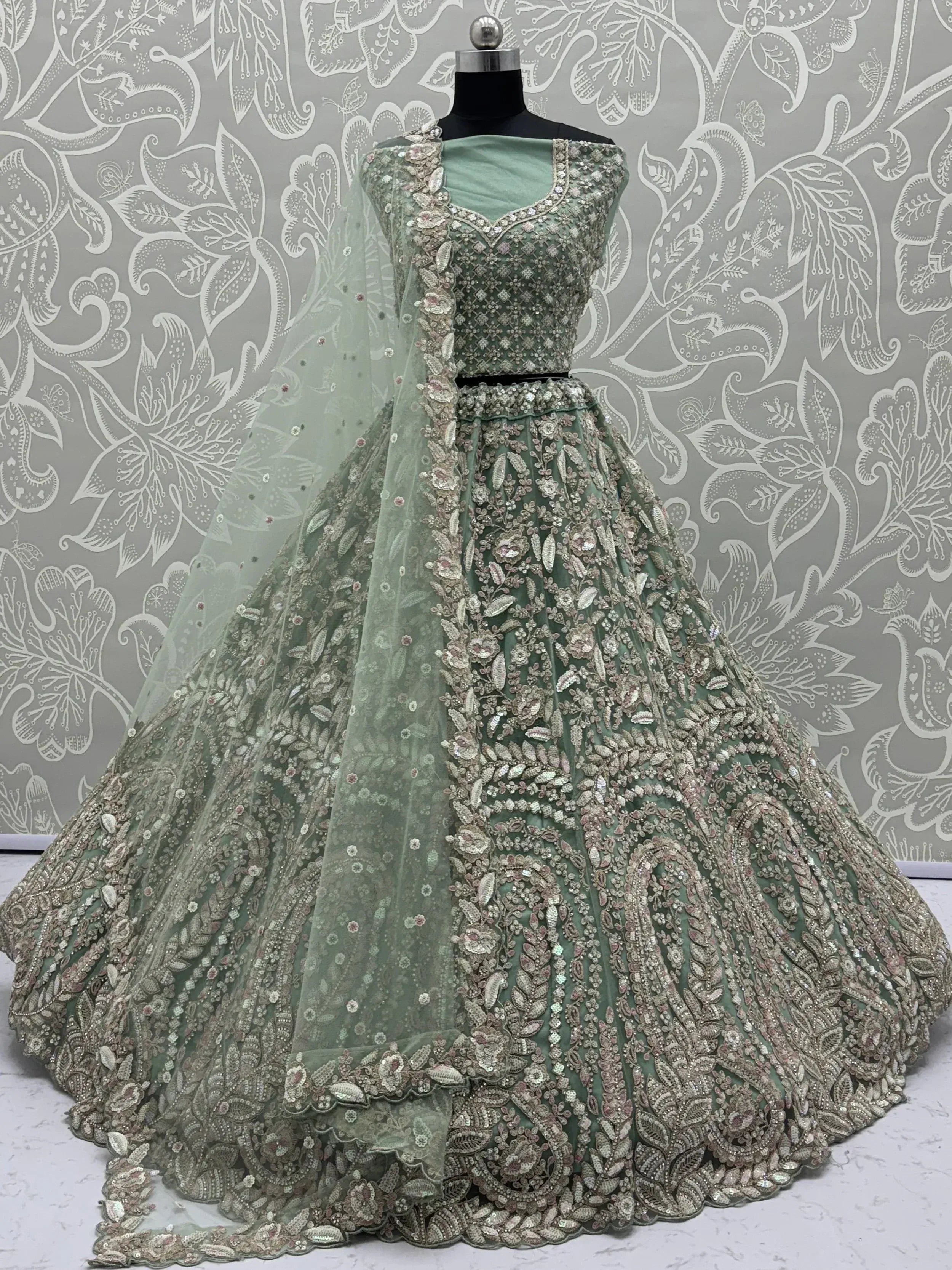 Mint green designer lehenga choli with heavy floral embroidery and sequins, perfect for weddings and parties
