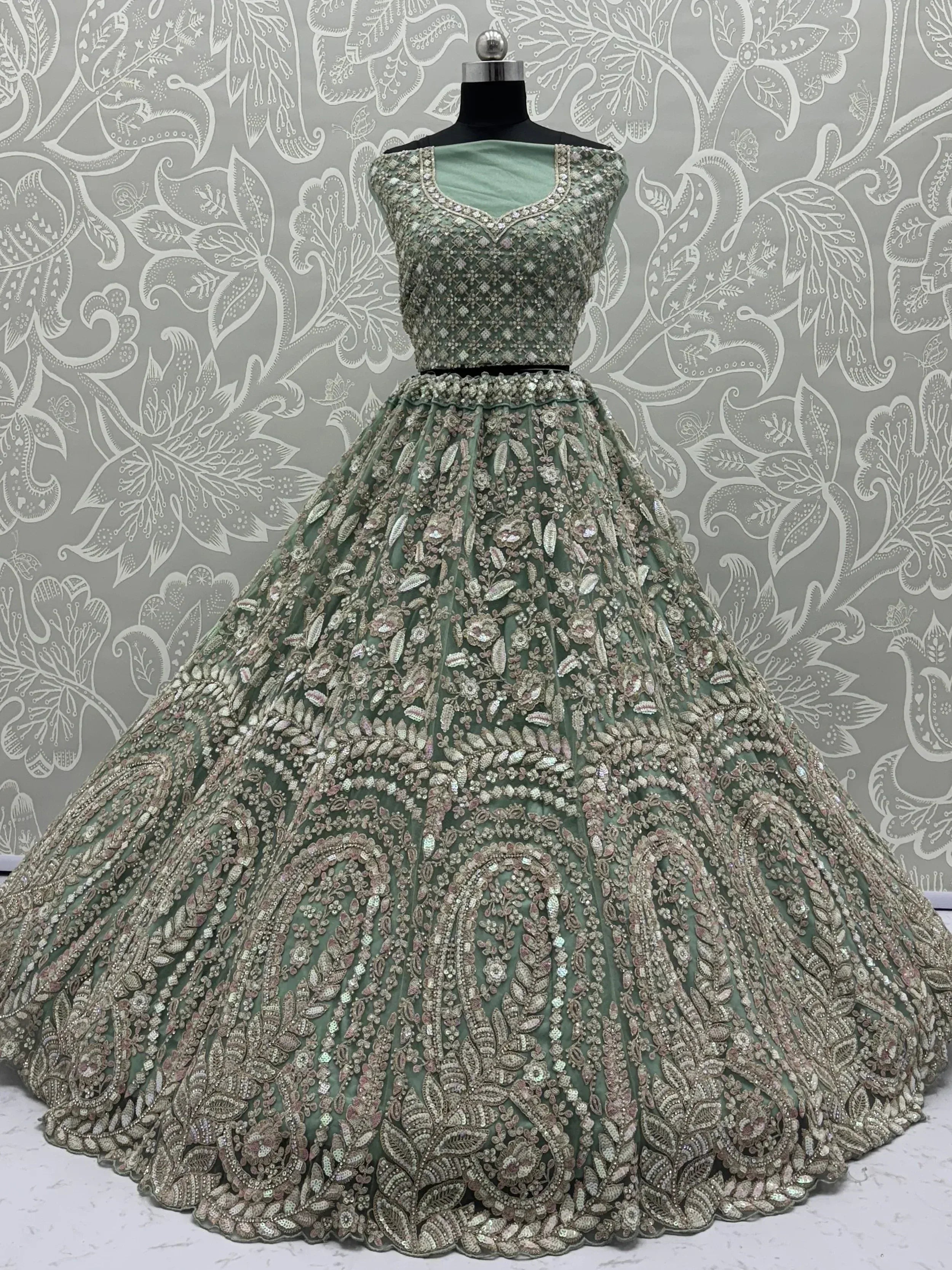 Mint green designer lehenga choli with heavy floral embroidery and sequins, perfect for weddings