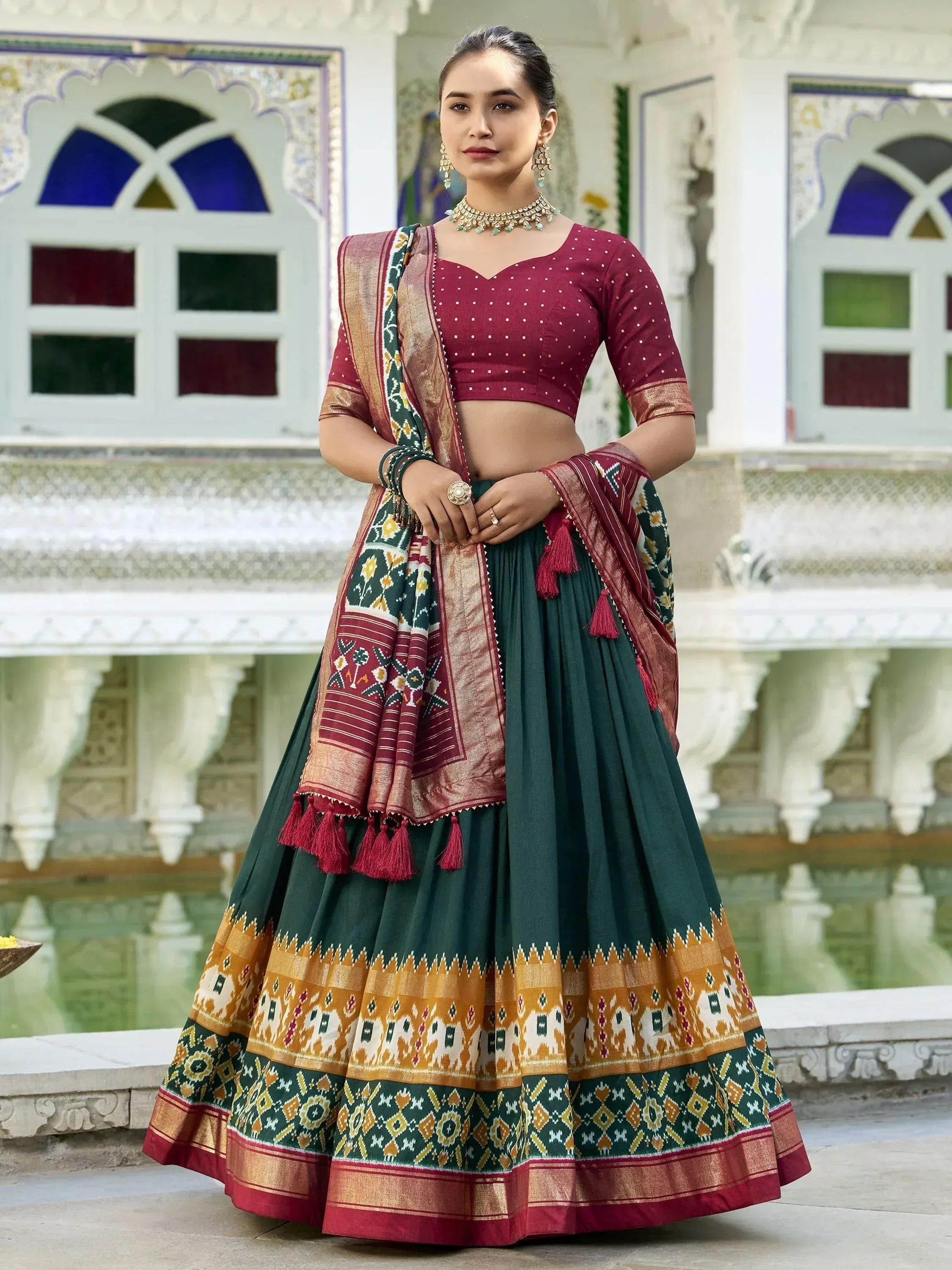 Maroon and green ethnic lehenga choli with ikat print, perfect for Indian weddings and festive occasions.