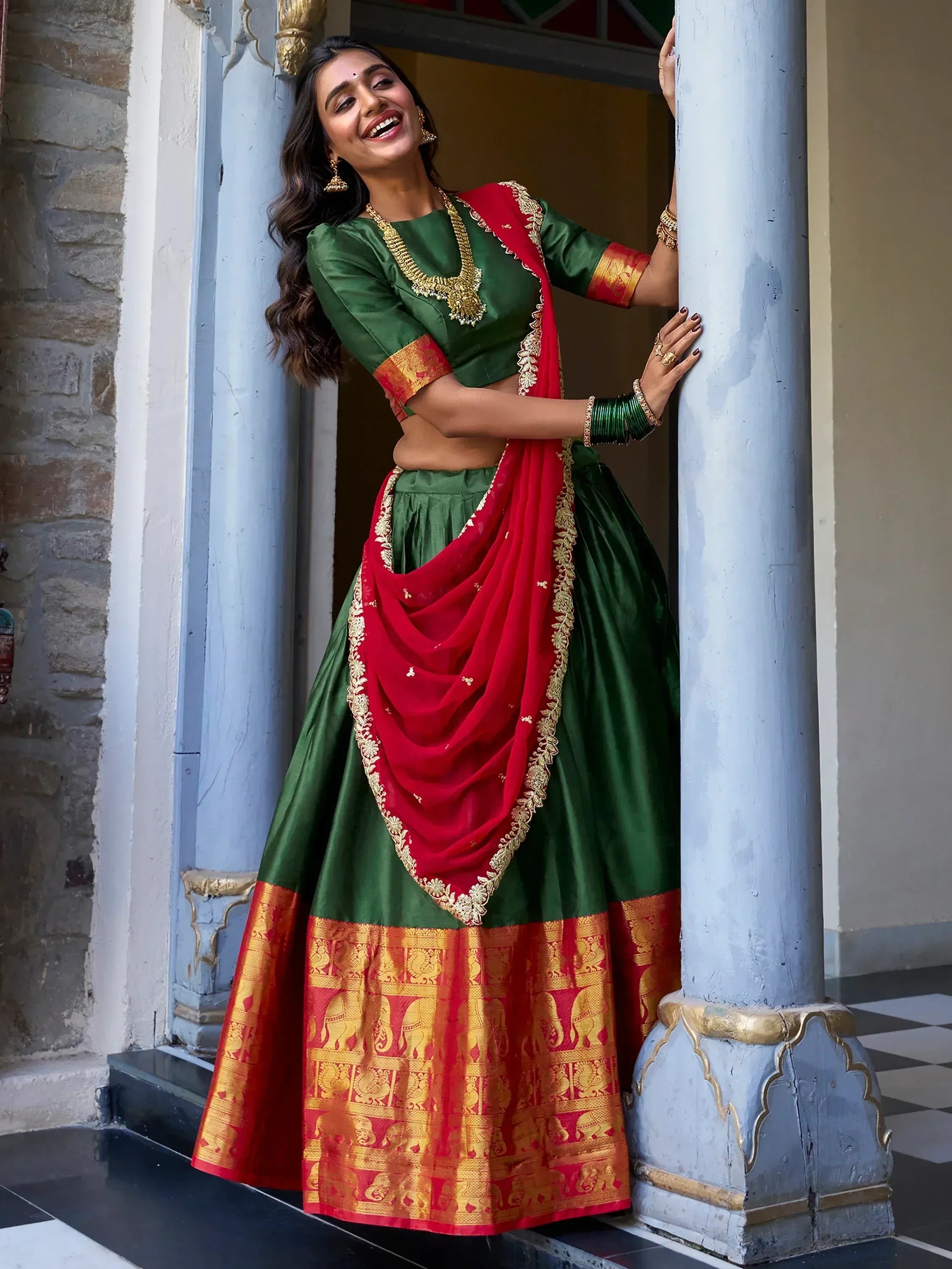 Green and red designer lehenga choli with gold embroidery, perfect for Indian ethnic wear occasions