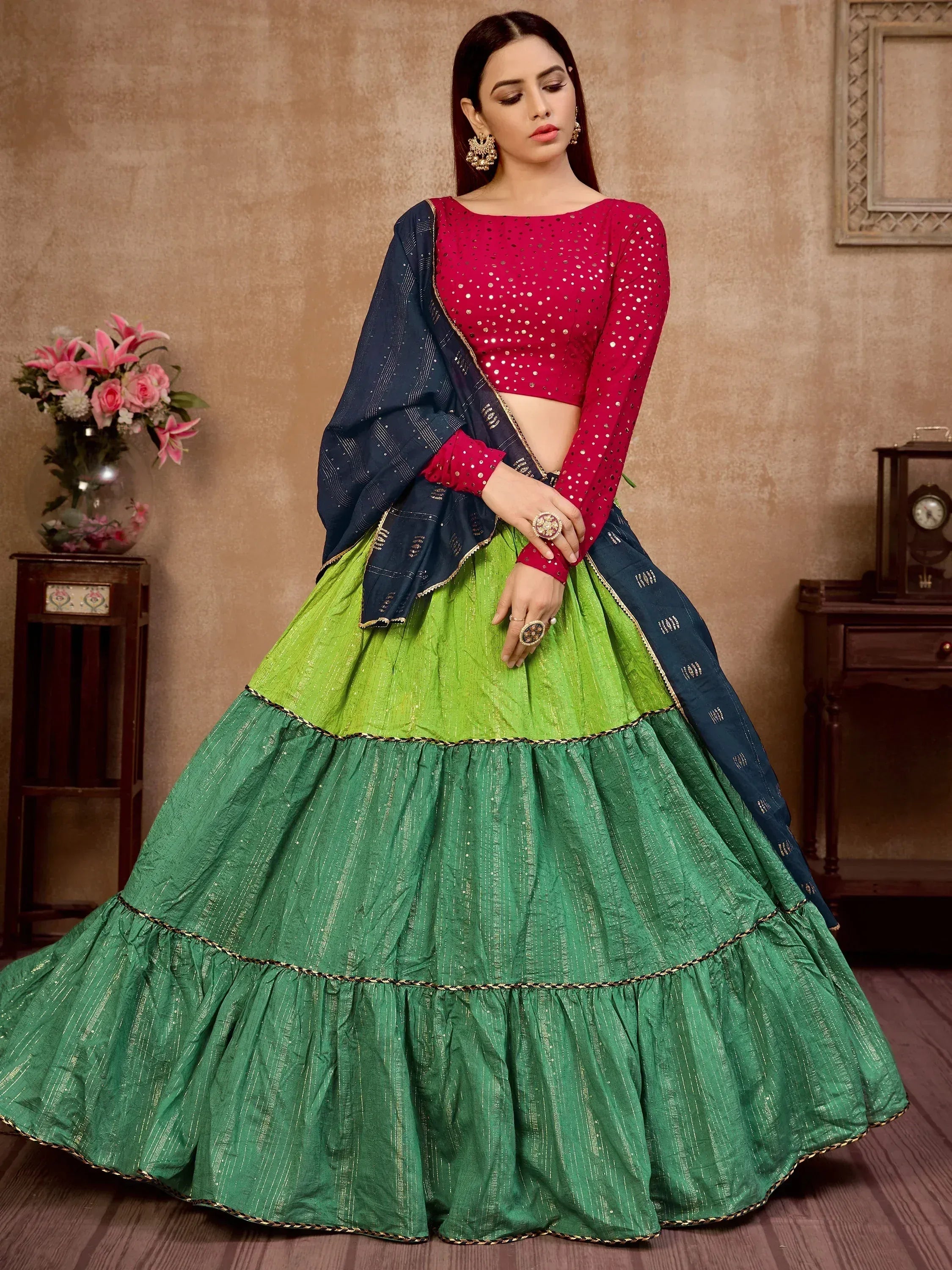 Vibrant green tiered lehenga with red sequin blouse and navy dupatta, perfect for Indian ethnic occasions.