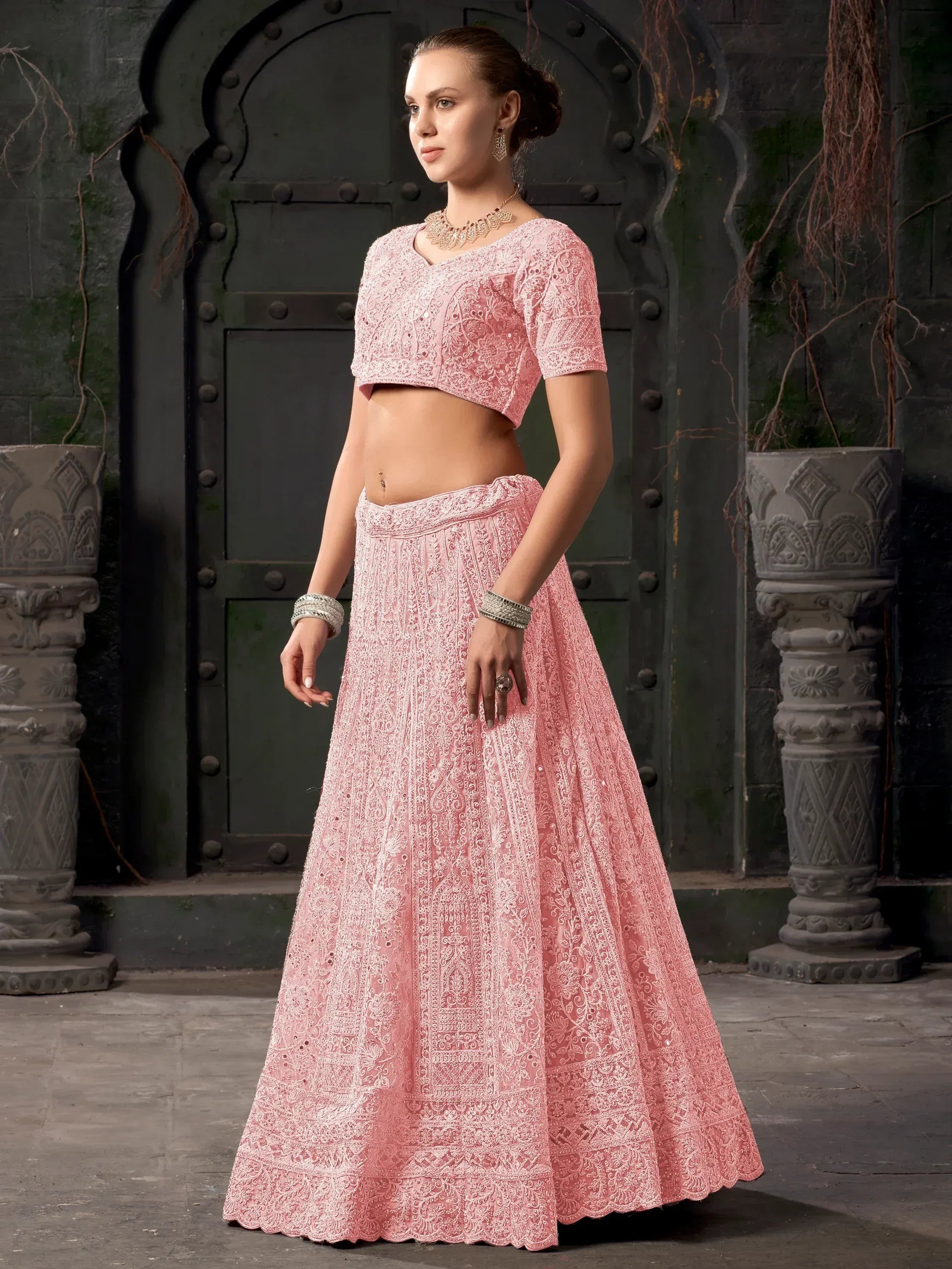 Pink embroidered lehenga choli with intricate lace detailing, perfect for Indian ethnic occasions
