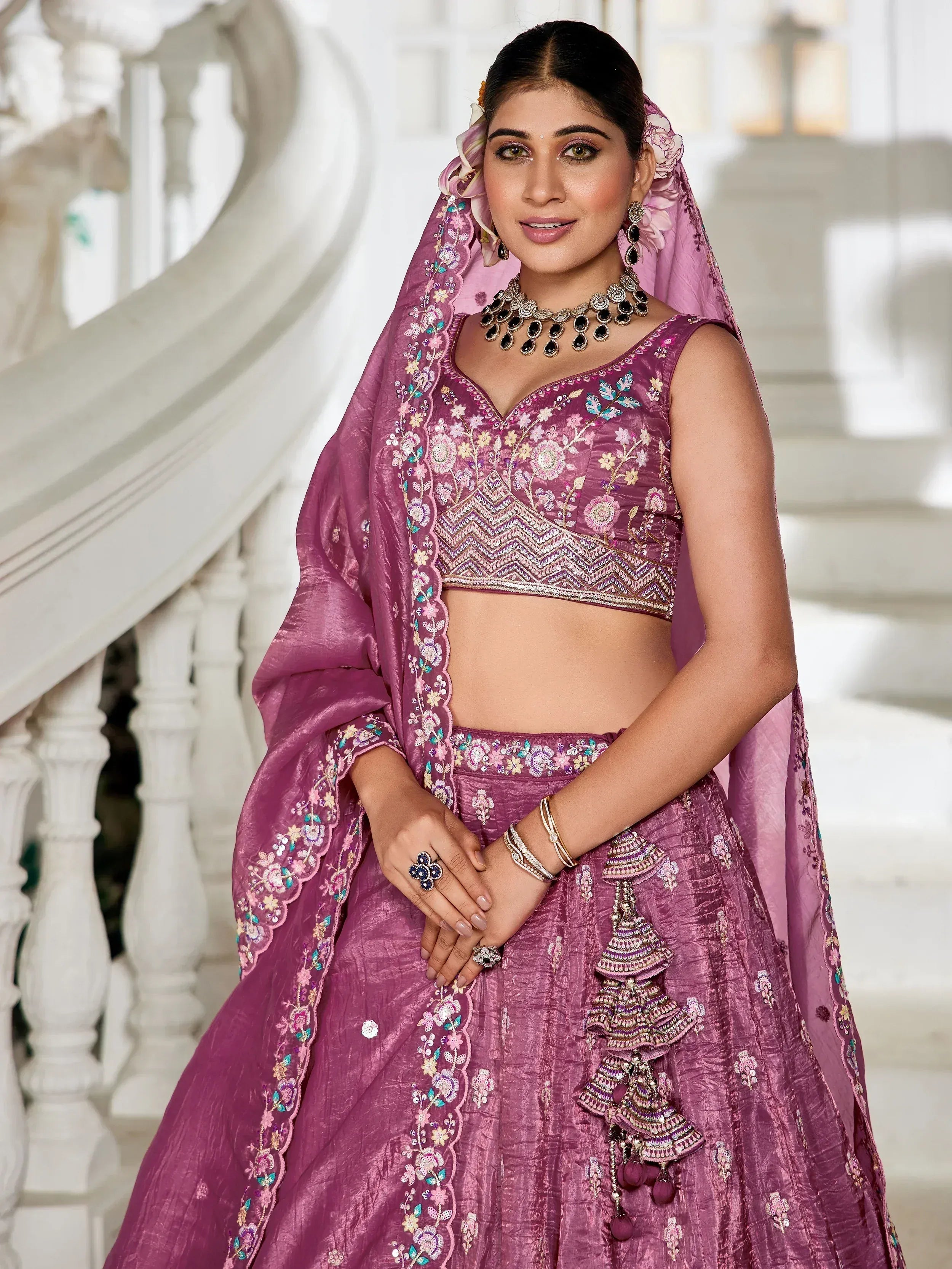 Purple embroidered lehenga choli with floral detailing and matching dupatta, perfect for Indian weddings or festive occasions.