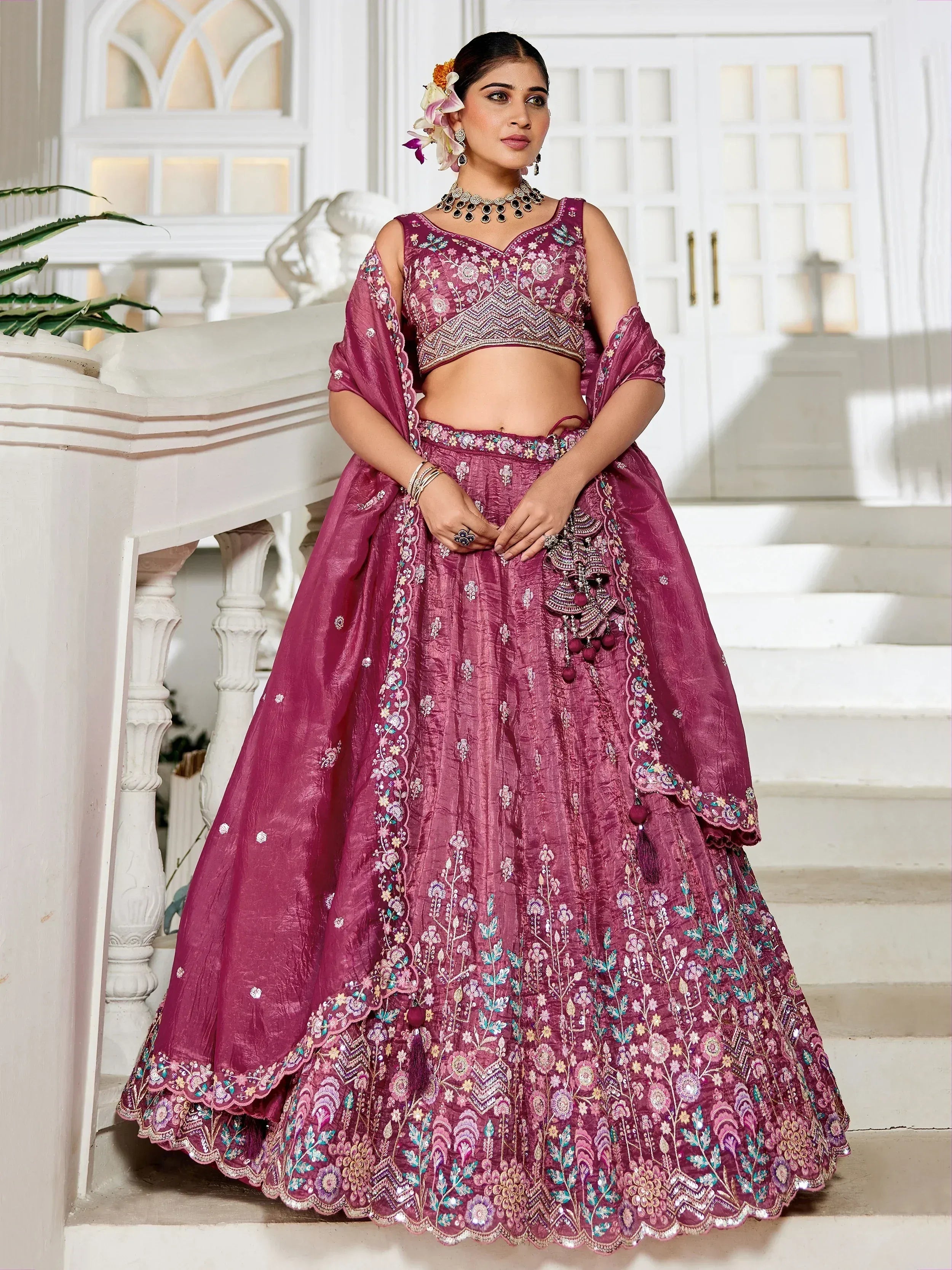 Purple embroidered lehenga choli with floral motifs, perfect for Indian weddings and festive occasions.