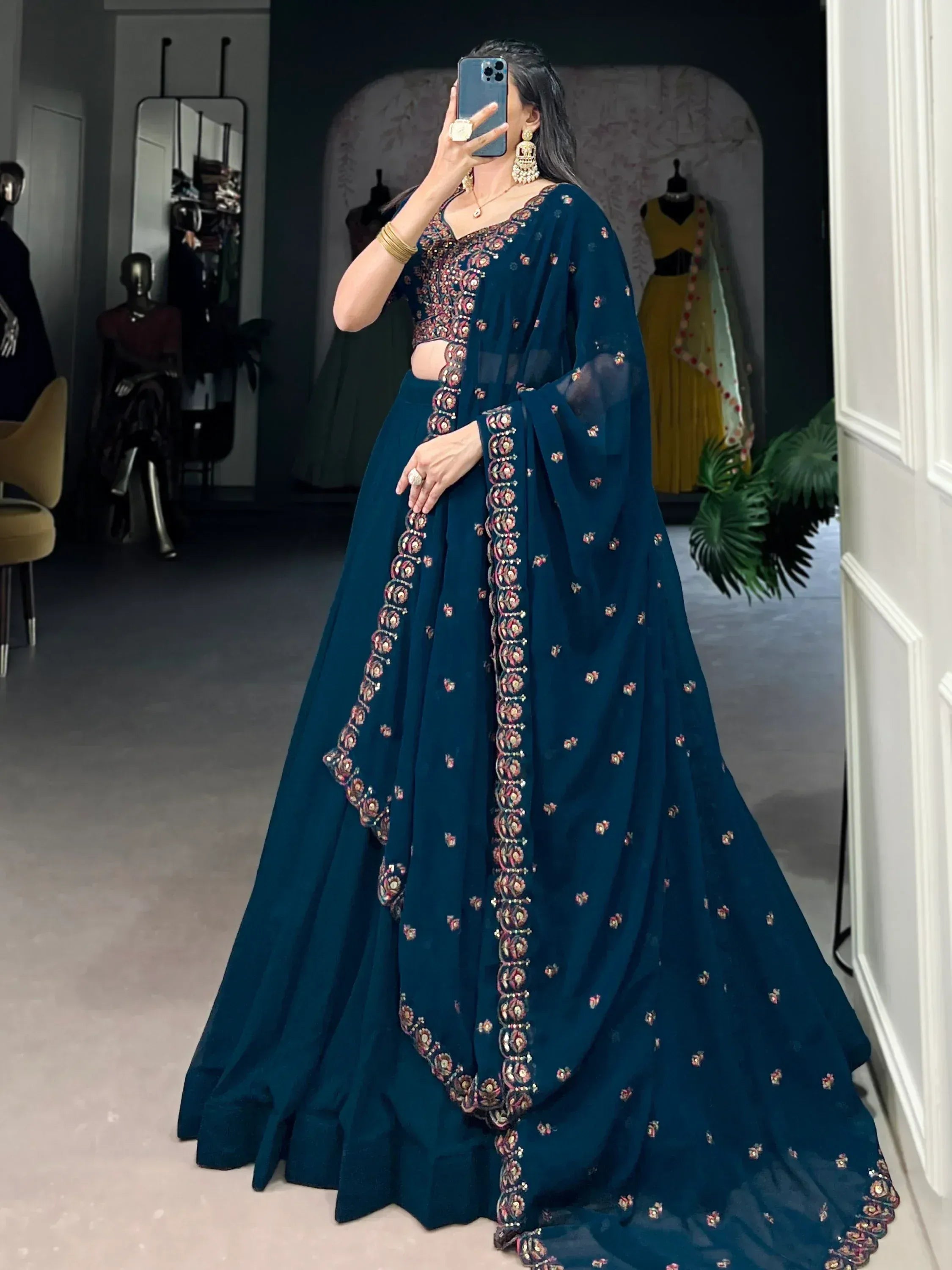 Teal embroidered lehenga choli with floral motifs, perfect for Indian ethnic wear and festive occasions