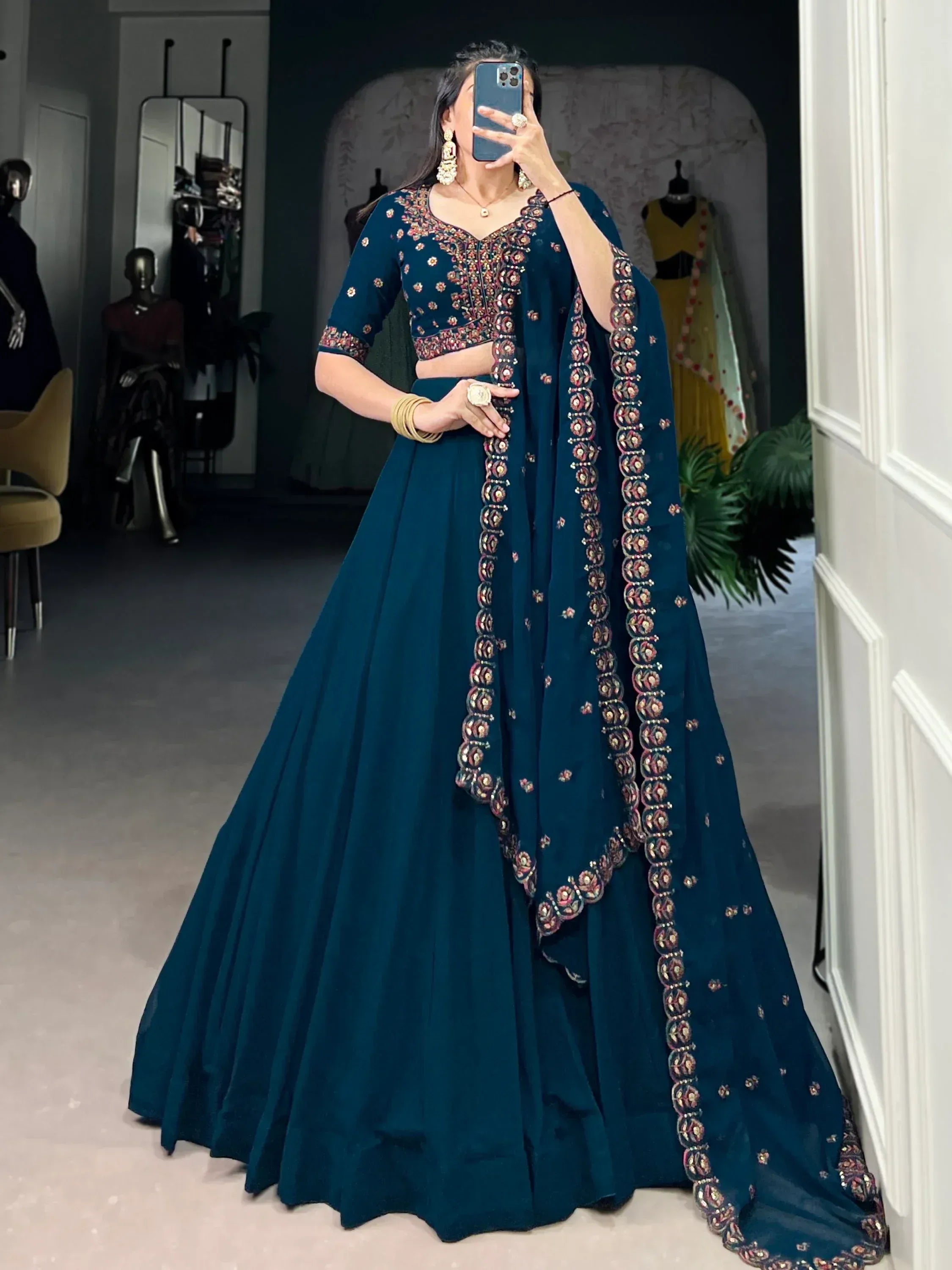 Teal embroidered lehenga choli with floral motifs, perfect for Indian ethnic wear and festive occasions.