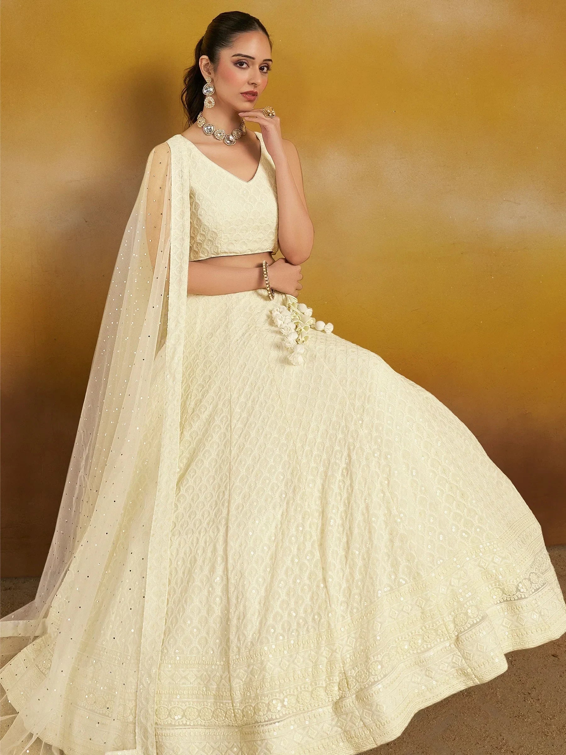 Elegant cream lehenga choli with floral embroidery and sequin dupatta, perfect for Indian weddings and festive occasions.