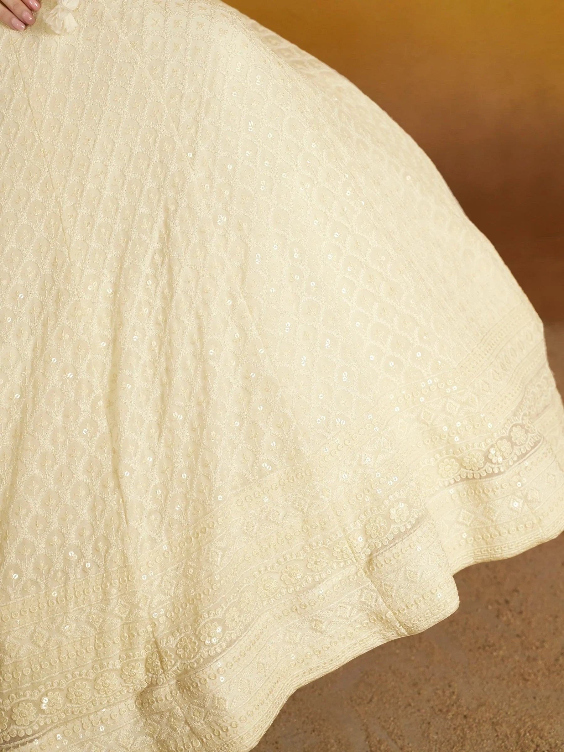 Cream embroidered lehenga with sequin detailing and floral border, perfect for Indian ethnic wear