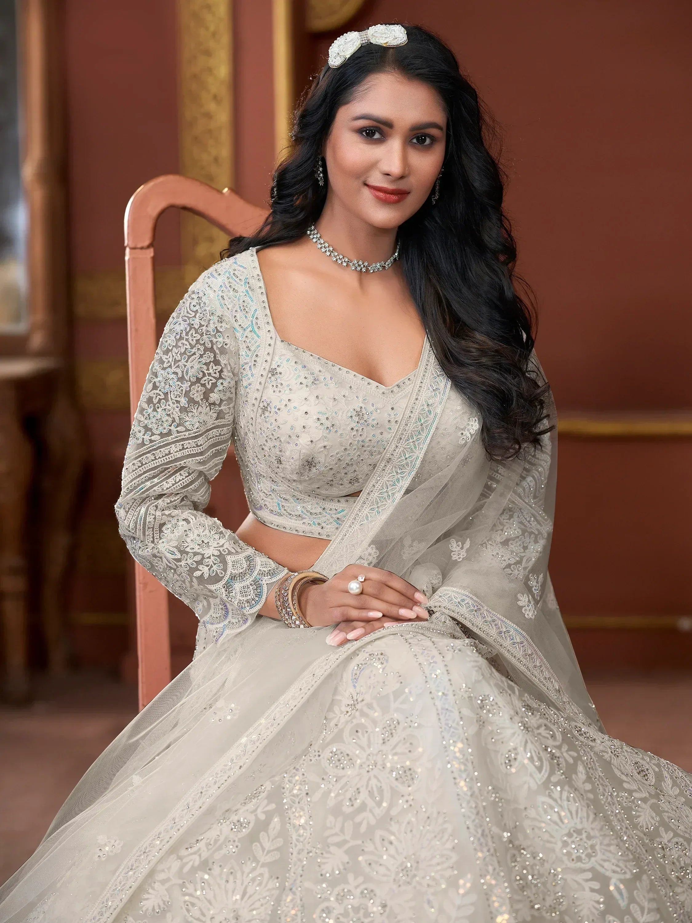 Elegant white embroidered lehenga choli with sequins, perfect for Indian weddings and festive occasions.