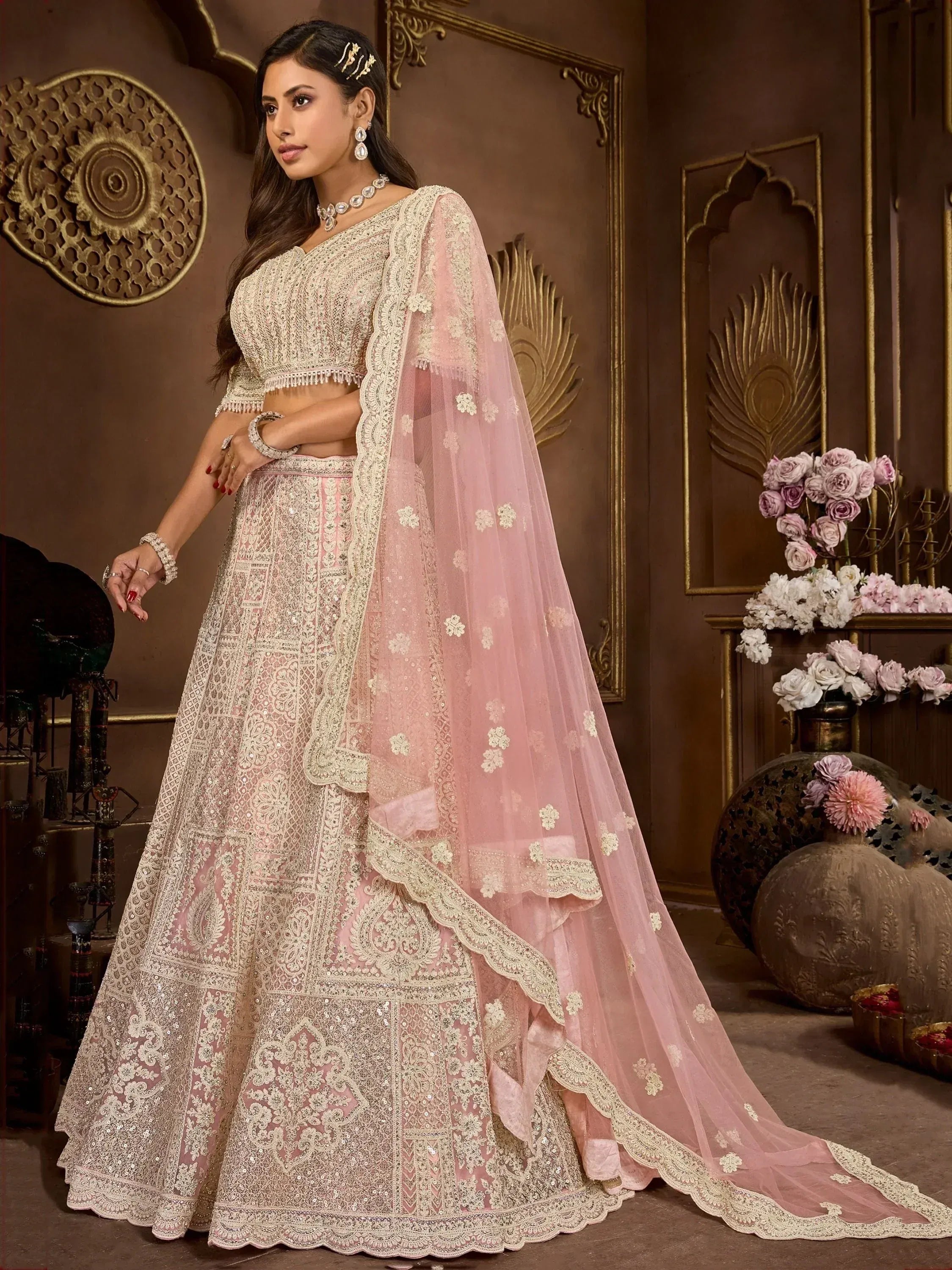 Elegant pink and cream designer lehenga choli with intricate embroidery and floral dupatta for Indian weddings