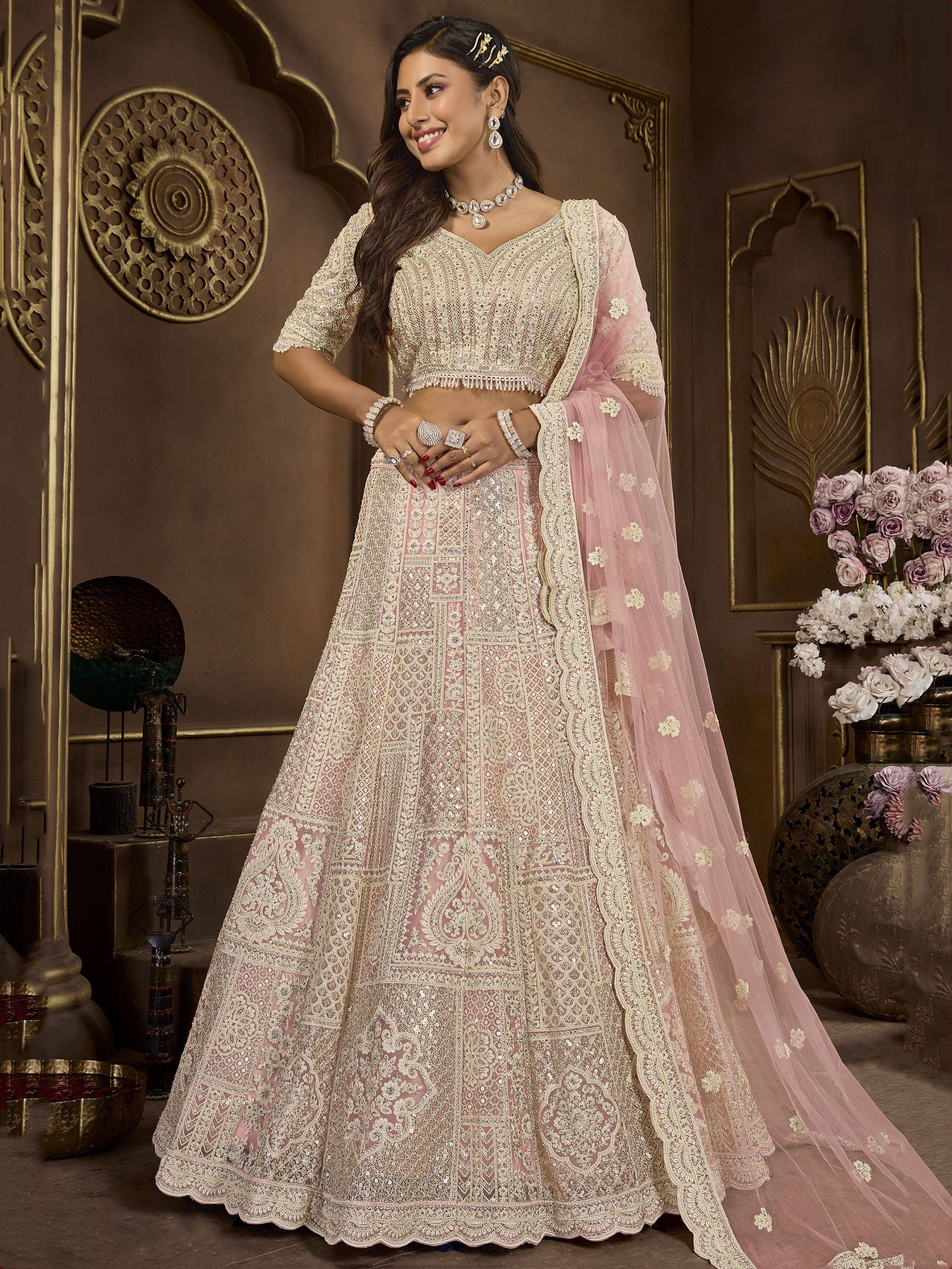 Elegant pink and gold embroidered lehenga choli with sheer dupatta, perfect for Indian weddings and festive occasions.