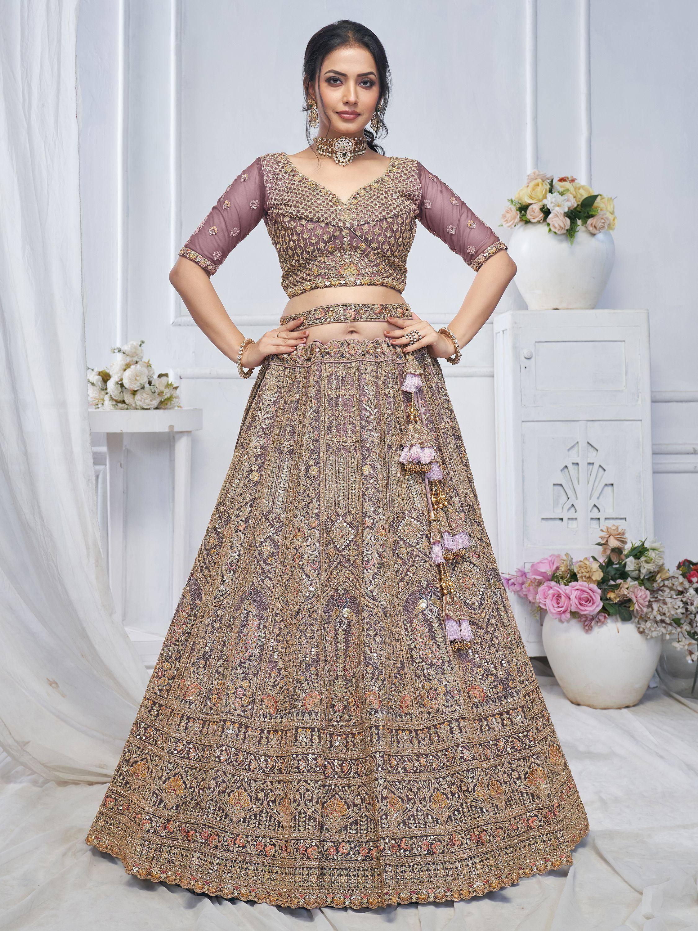 Elegant mauve lehenga choli with gold embroidery and tassels, perfect for Indian weddings and festive occasions.