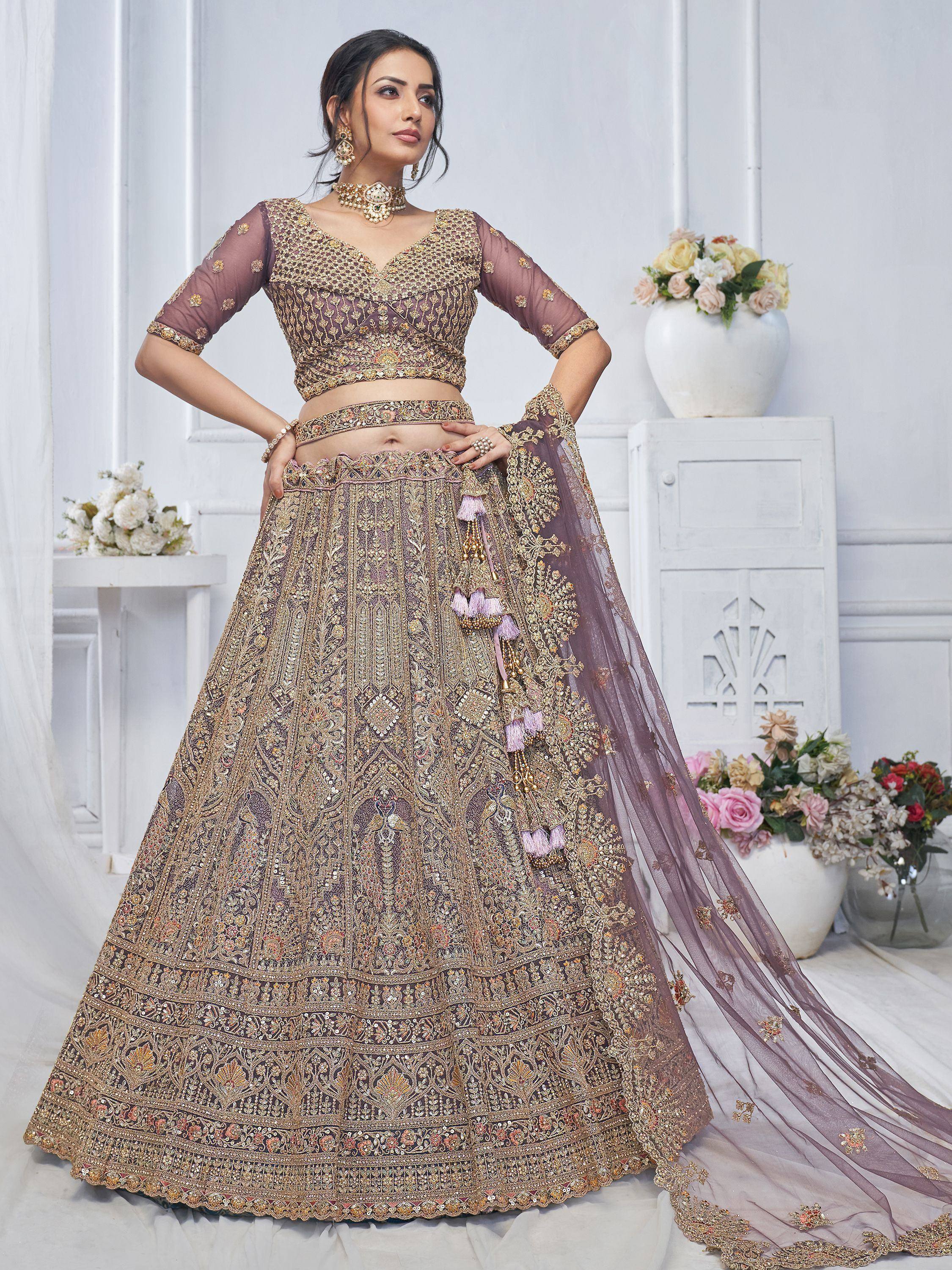 Elegant mauve lehenga choli with heavy gold embroidery, perfect for Indian weddings and festive occasions.