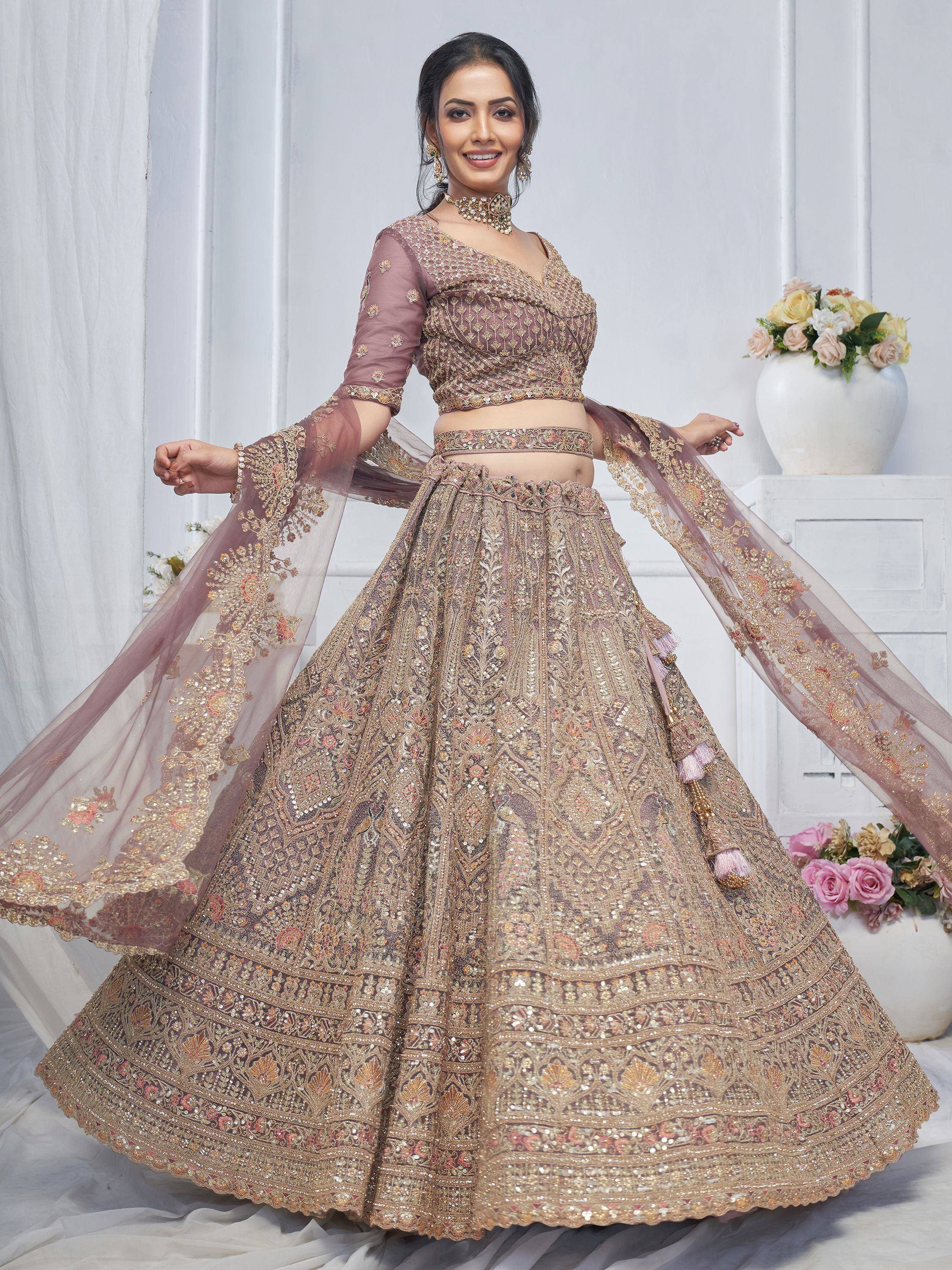 Elegant mauve lehenga choli with heavy gold embroidery, perfect for Indian weddings and festive occasions.