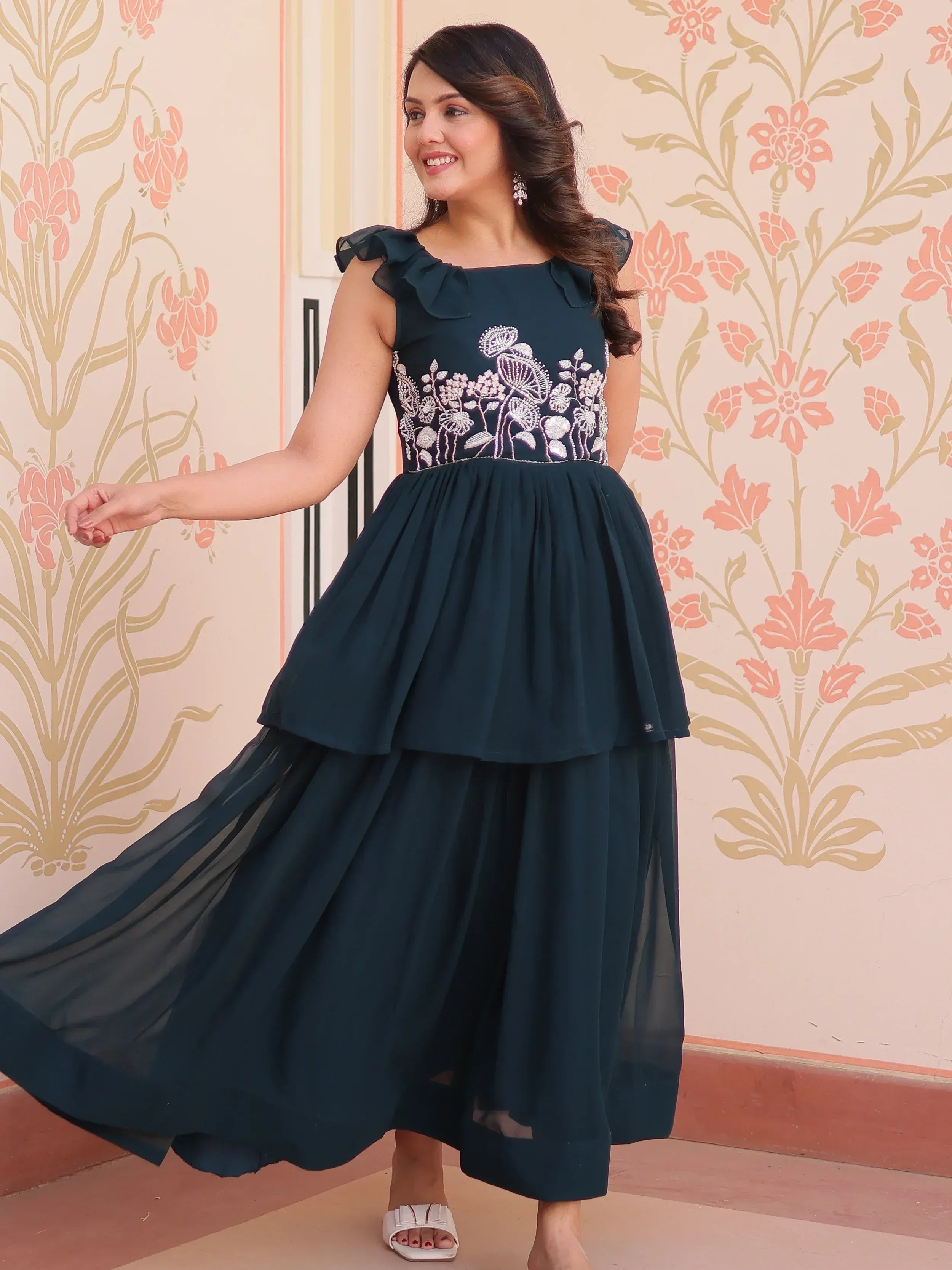 Elegant dark green ethnic gown with floral embroidery and ruffle sleeves, perfect for Indian occasions.