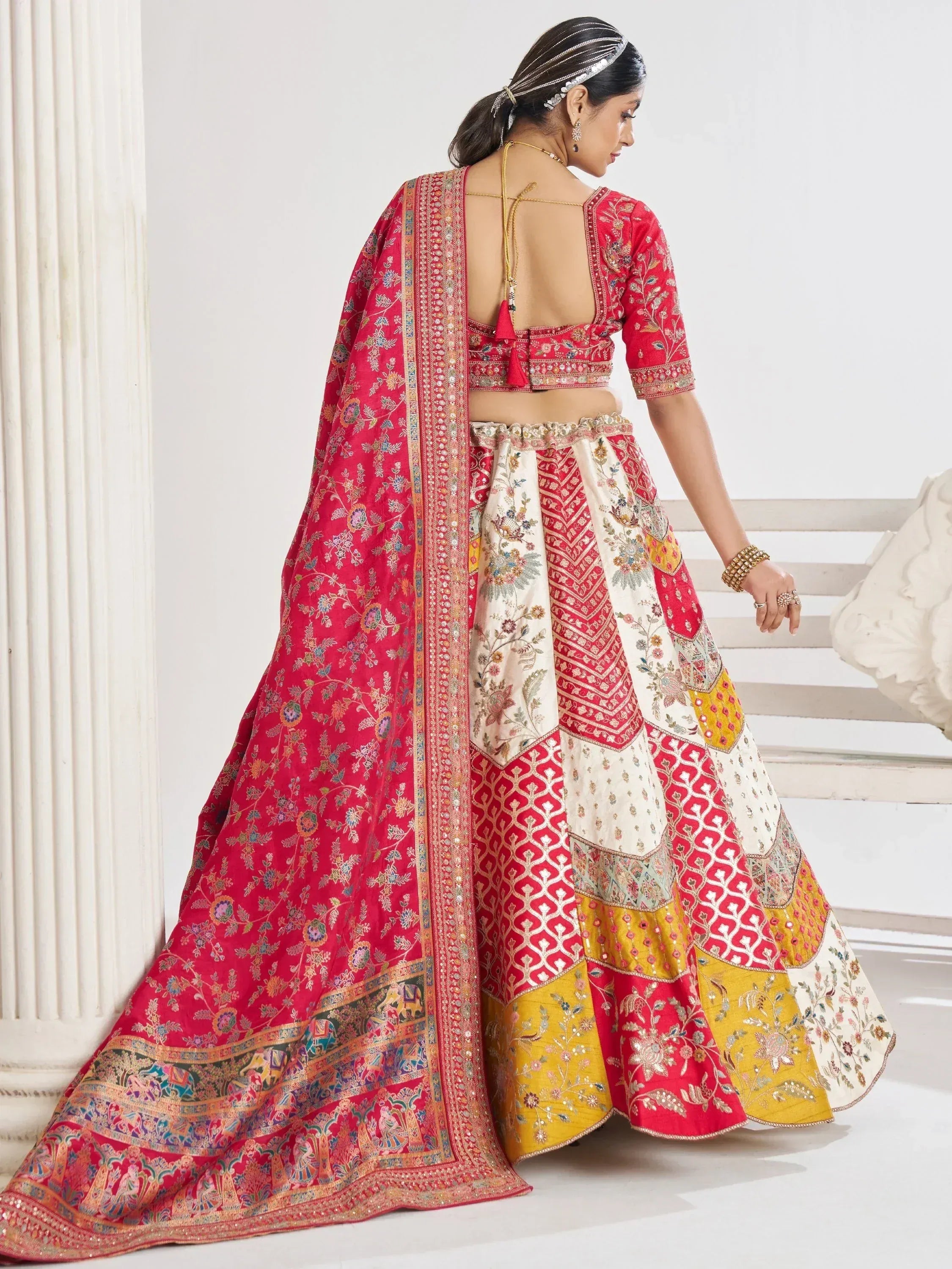 Red and gold embroidered lehenga choli with floral patterns, perfect for Indian weddings and festive occasions.