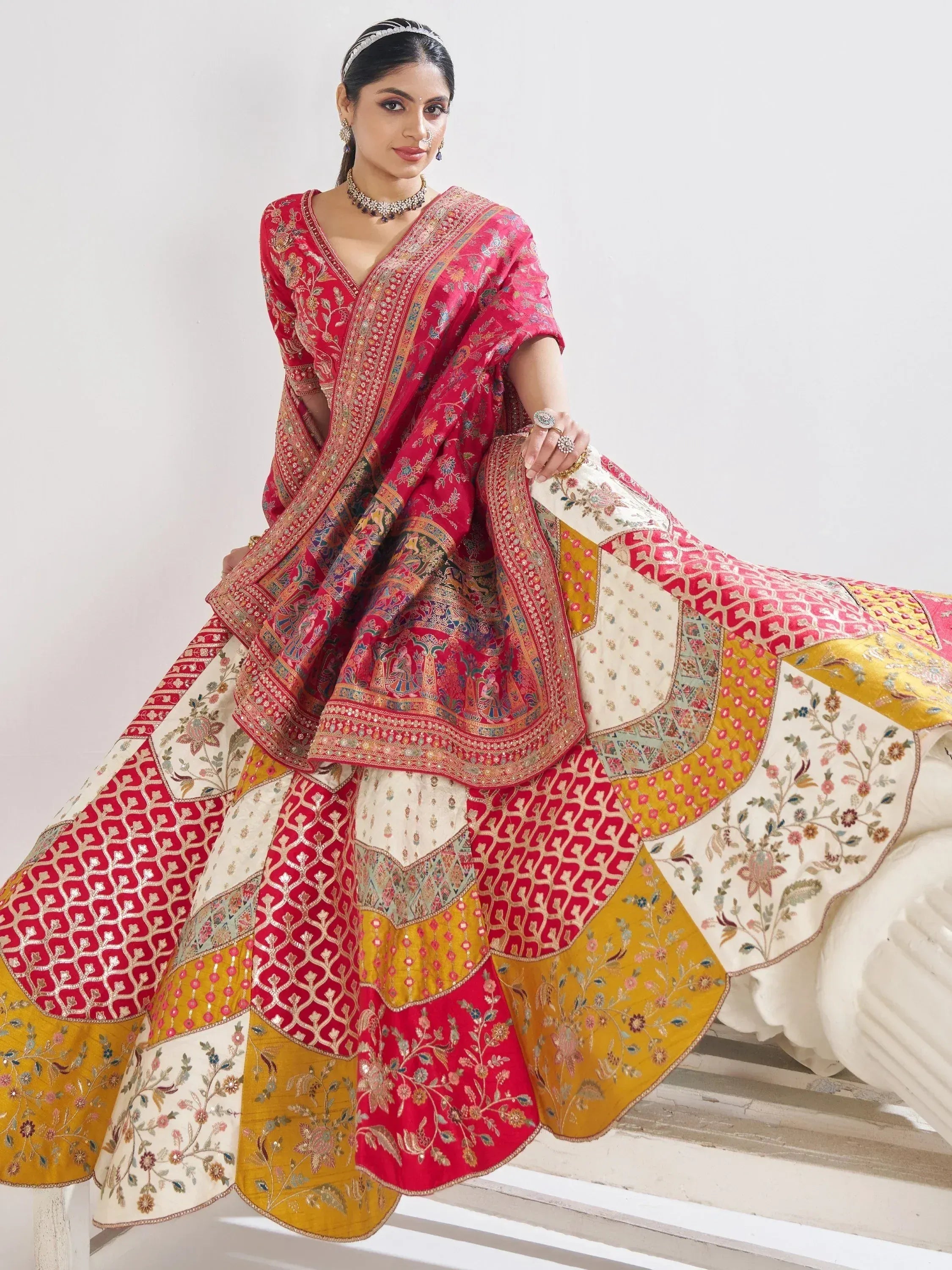 Red and gold embroidered lehenga choli with floral and geometric patterns, perfect for Indian ethnic wear